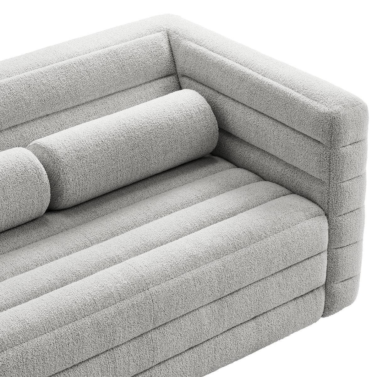 Close view of the Relle loveseat arm and bolster pillow, highlighting the plush boucle texture and channel design. || EEI-7137-NPT || detail_studio
