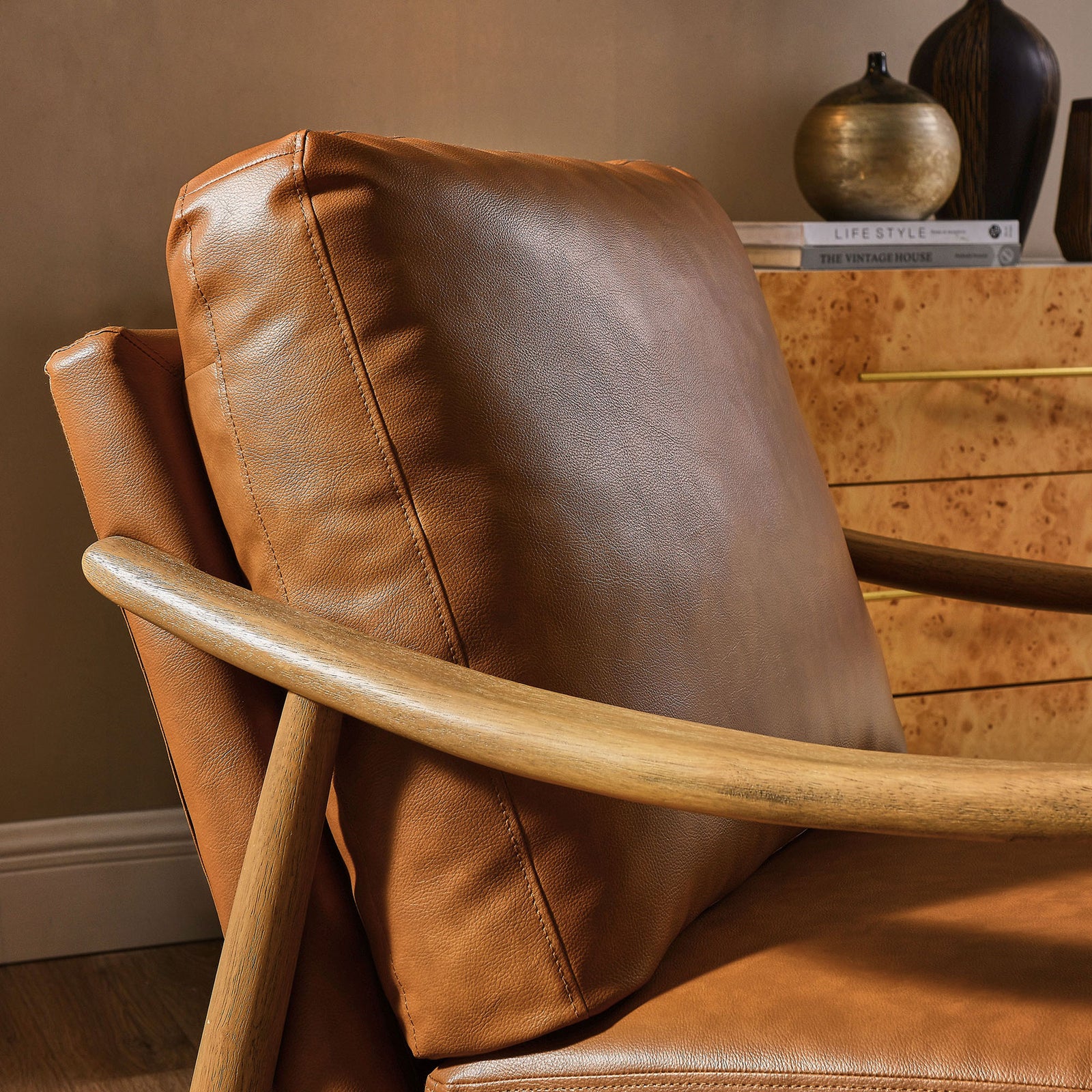 Textured vegan leather cushions offer cozy comfort against a sleek curved wood frame || EEI-7138-TAN-WAL || detail_room