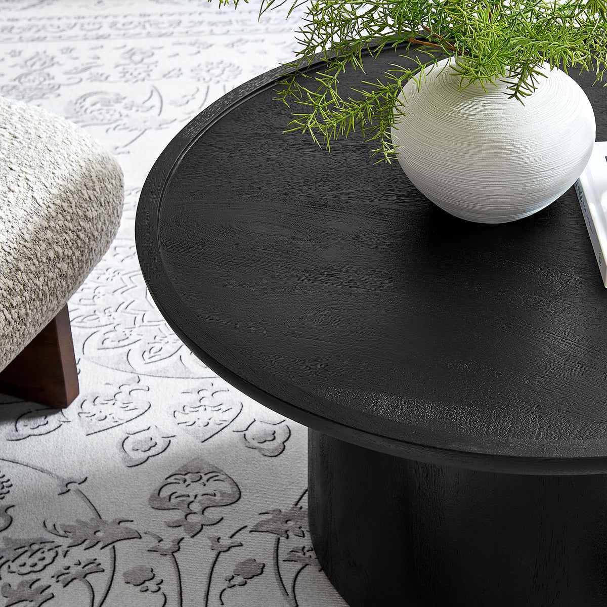 Bold black mango wood coffee table with a rimmed round top that elevates modern living rooms || EEI-7144-BLK || detail_room
