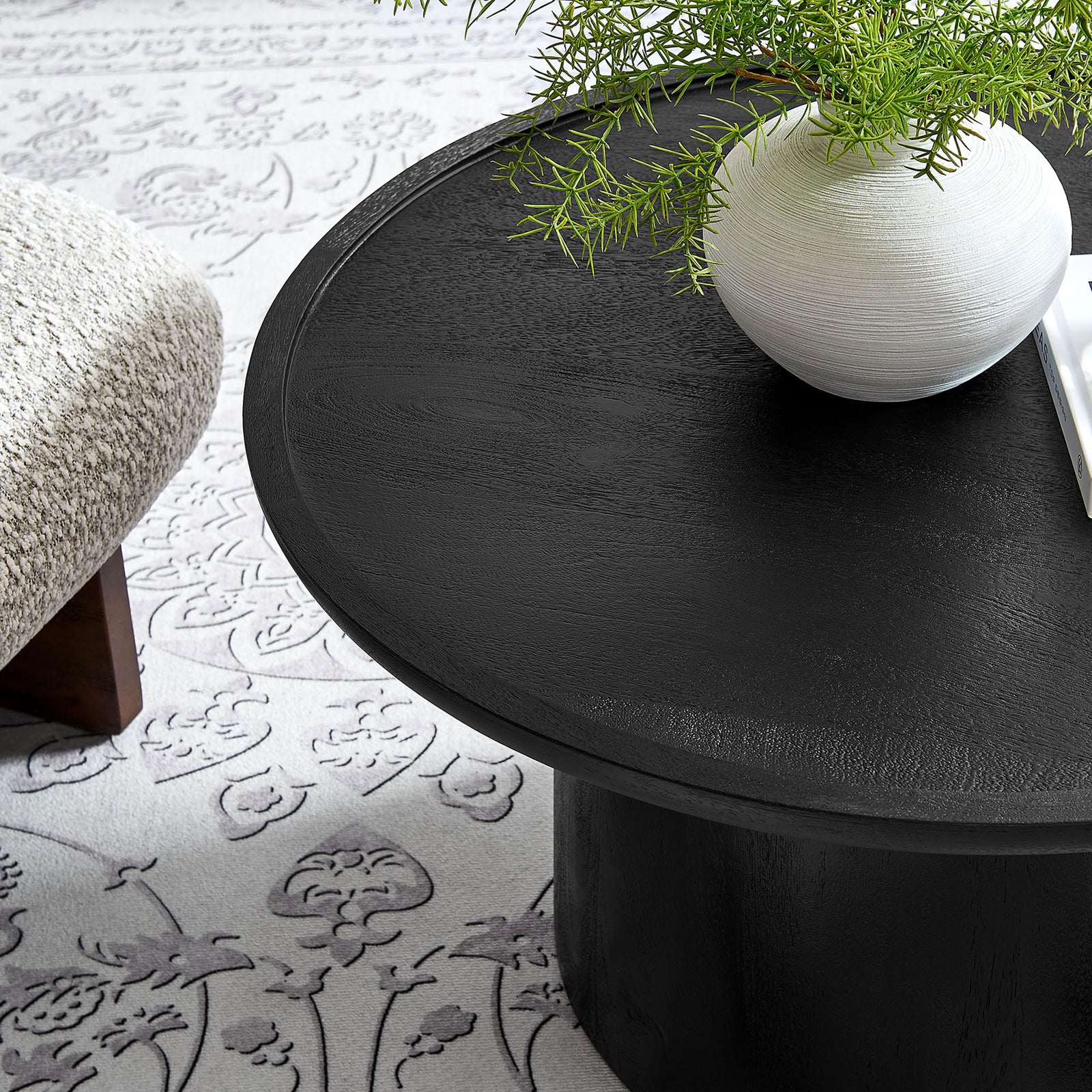 Bold black mango wood coffee table with a rimmed round top that elevates modern living rooms || EEI-7144-BLK || detail_room