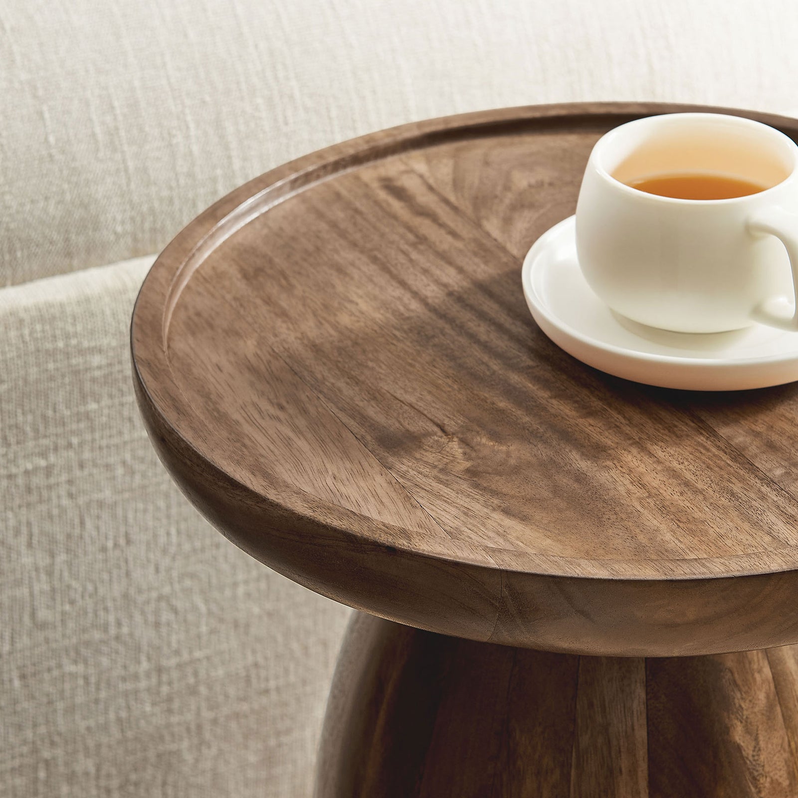 Walnut mango wood side table styled beside a sofa with tea cup on the tray top || EEI-7145-WAL || detail_room