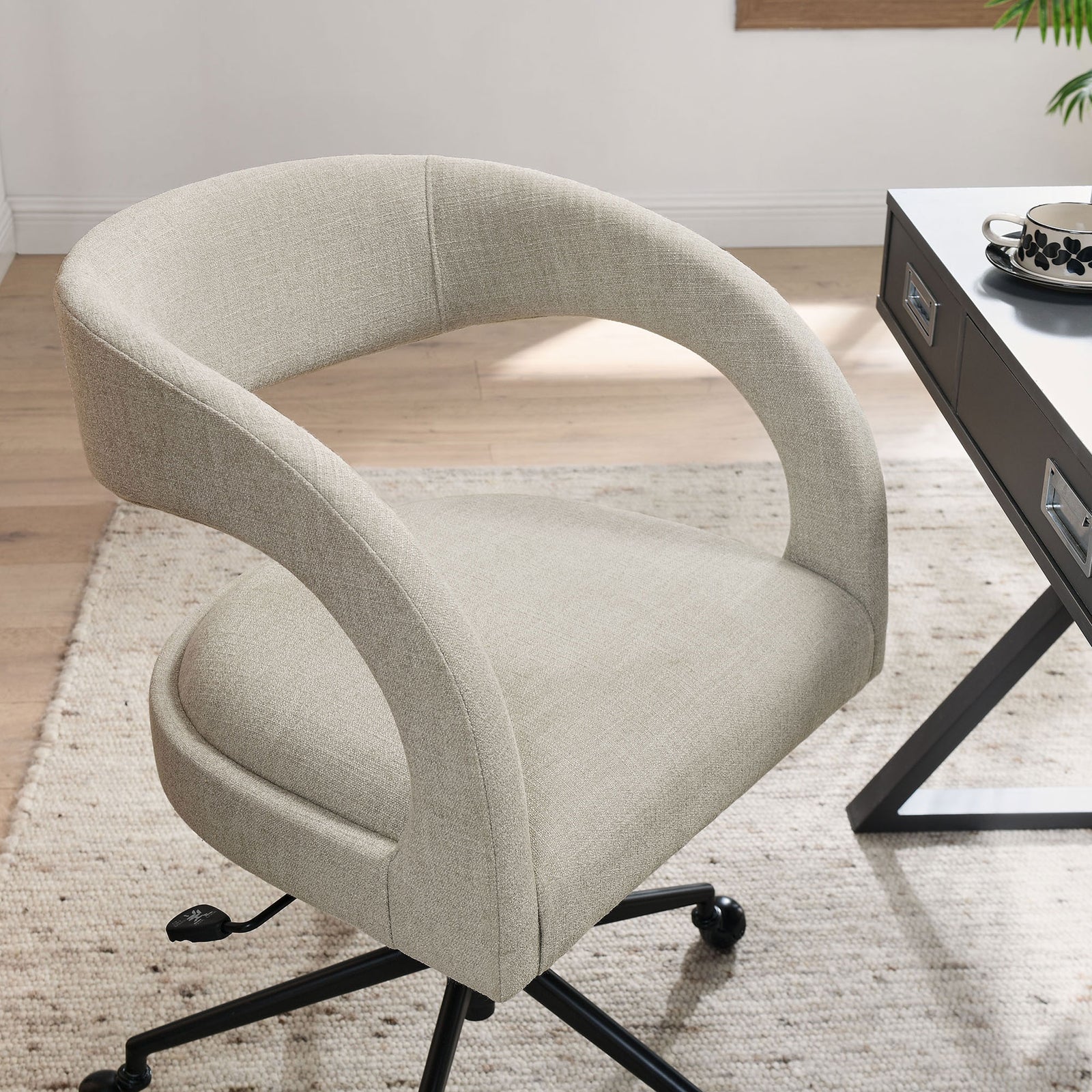 Linen barrel office chair styled beside a modern desk on a neutral area rug || EEI-7149-LIN || detail_room