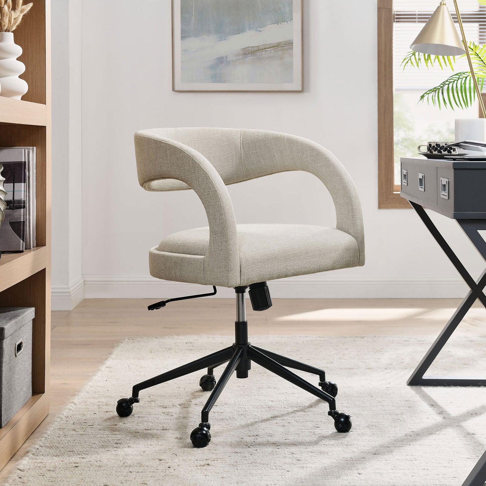 Pinnacle linen office chair in a bright home office with wood shelving and natural light || EEI-7149-LIN || front_angle_room