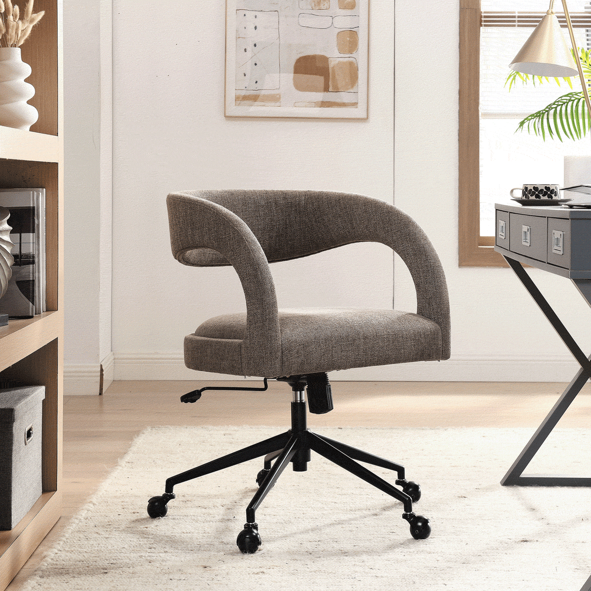 Mocha upholstered office chair with curved open back adds soft texture and comfort to a light-filled office || EEI-7149-MOC || front_angle_room