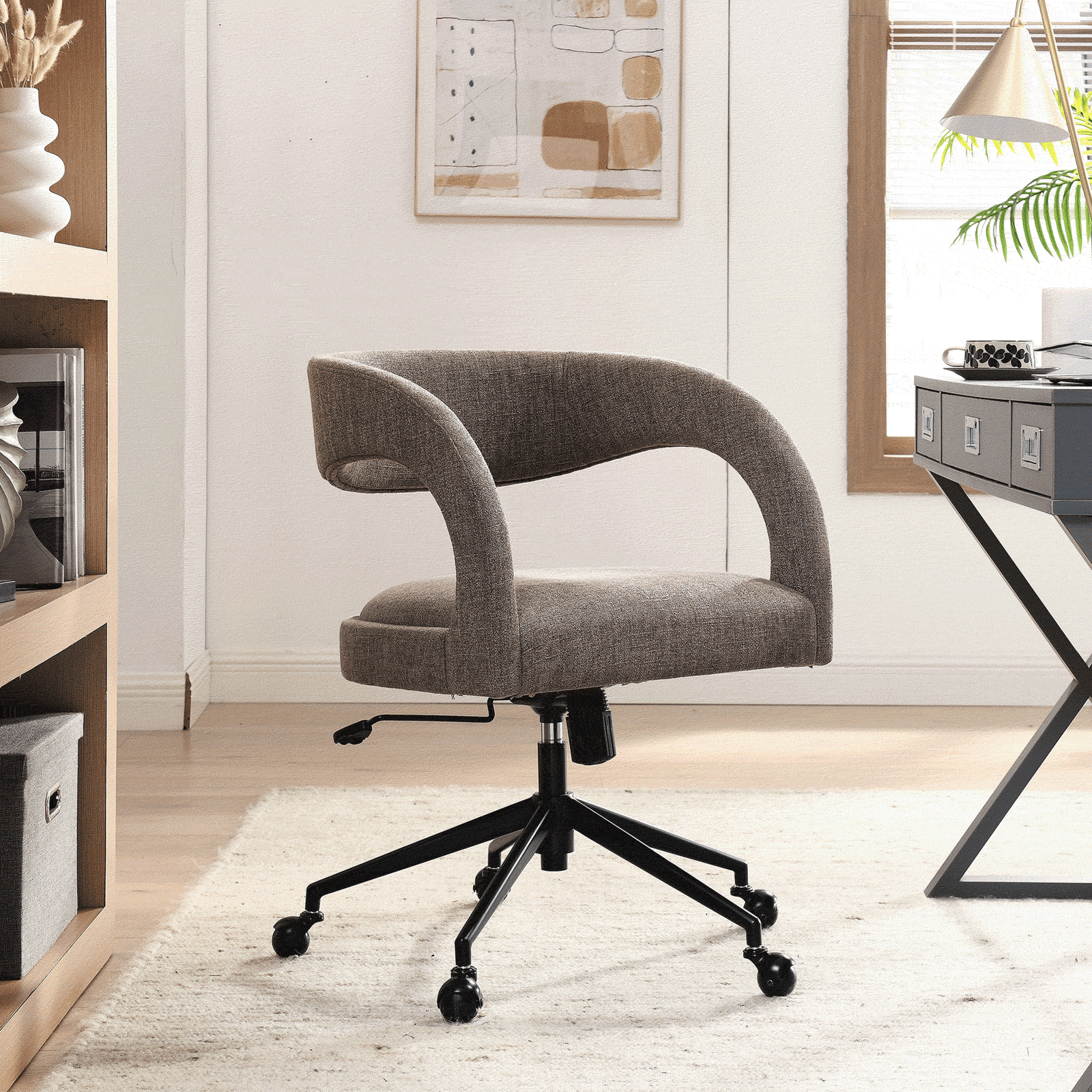 Mocha upholstered office chair with curved open back adds soft texture and comfort to a light-filled office || EEI-7149-MOC || front_angle_room