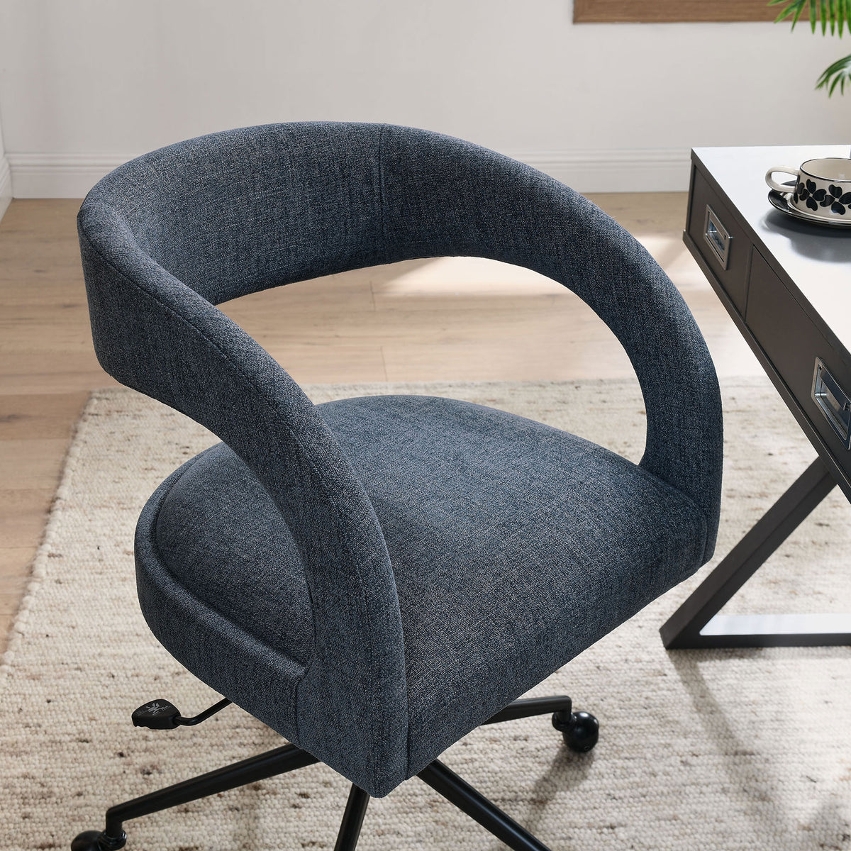 Slate blue office chair styled beside a modern desk in a bright home office setting. || EEI-7149-SLB || front_angle_room