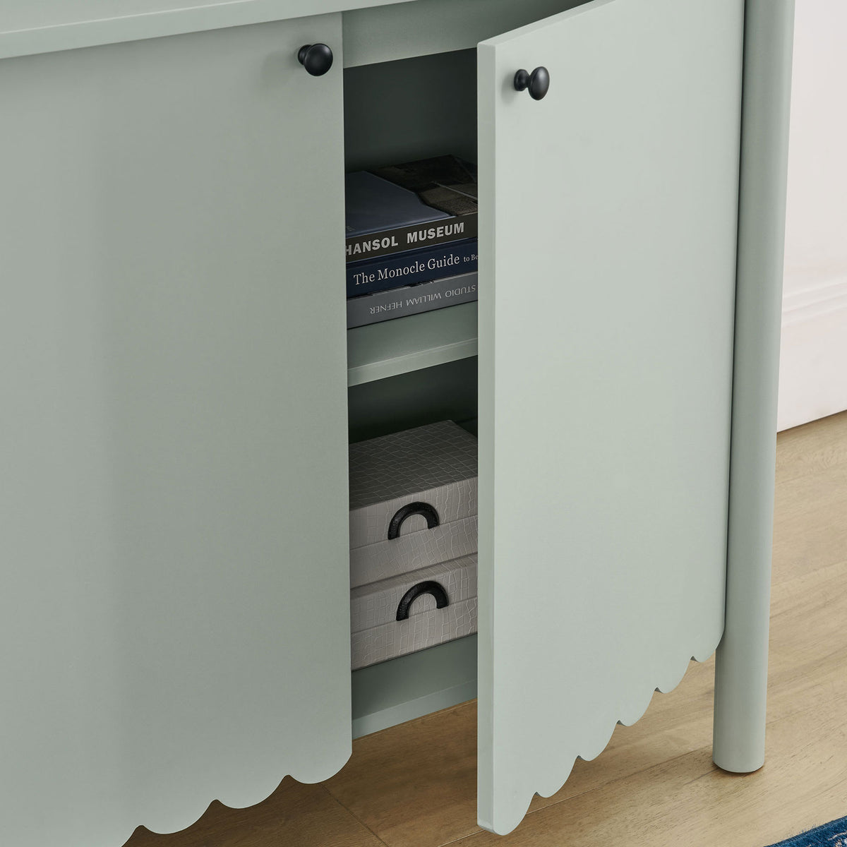 Styled cabinet in a modern room with door open to show organized storage for books and decor || EEI-7152-SGE || storage_open_room