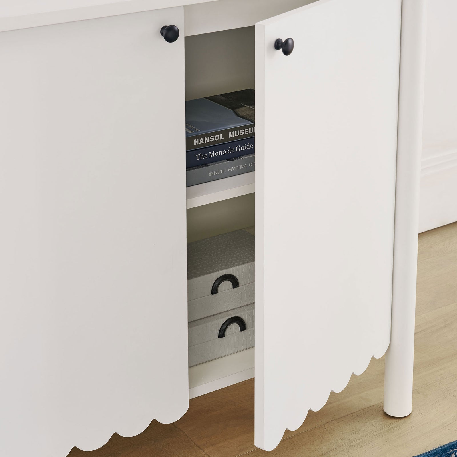 White Emmeline sideboard neatly storing books and boxes on adjustable interior shelves || EEI-7152-WHI || storage_open_room