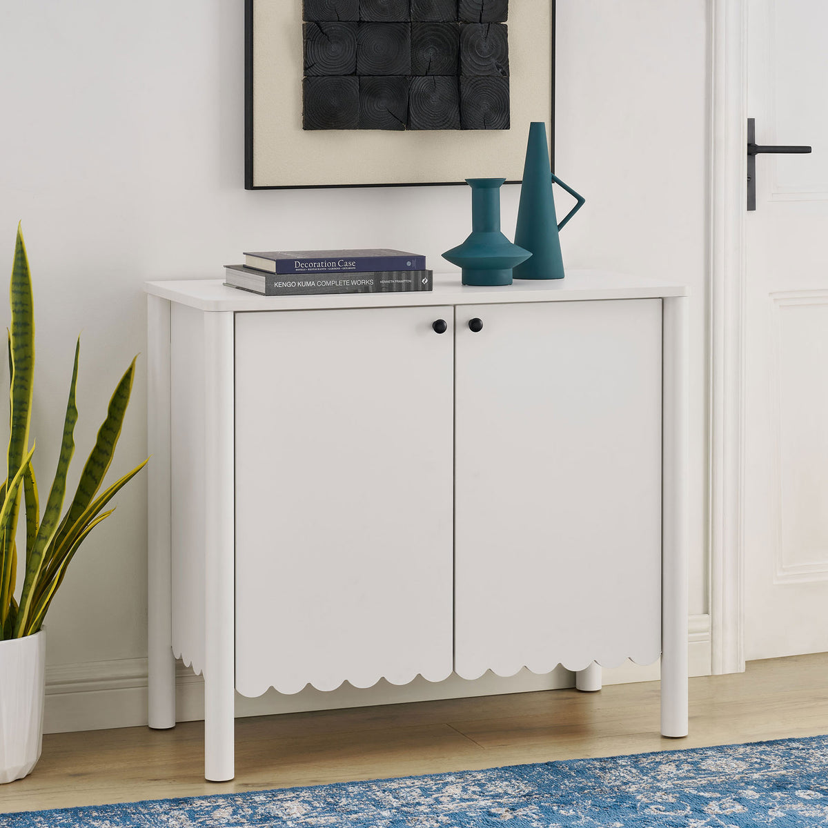 White Emmeline sideboard styled in a modern room with rug, artwork, and greenery || EEI-7152-WHI || front_angle_room