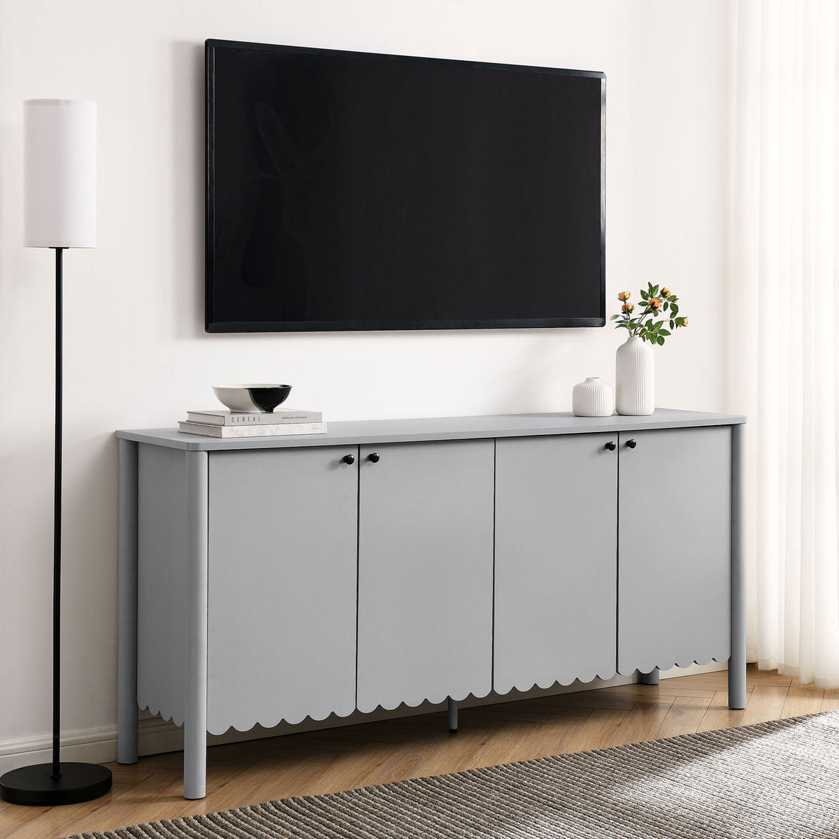 Light gray Emmeline sideboard used as a sleek media console beneath a wall mounted TV in a modern living room || EEI-7153-LGR || front_angle_room