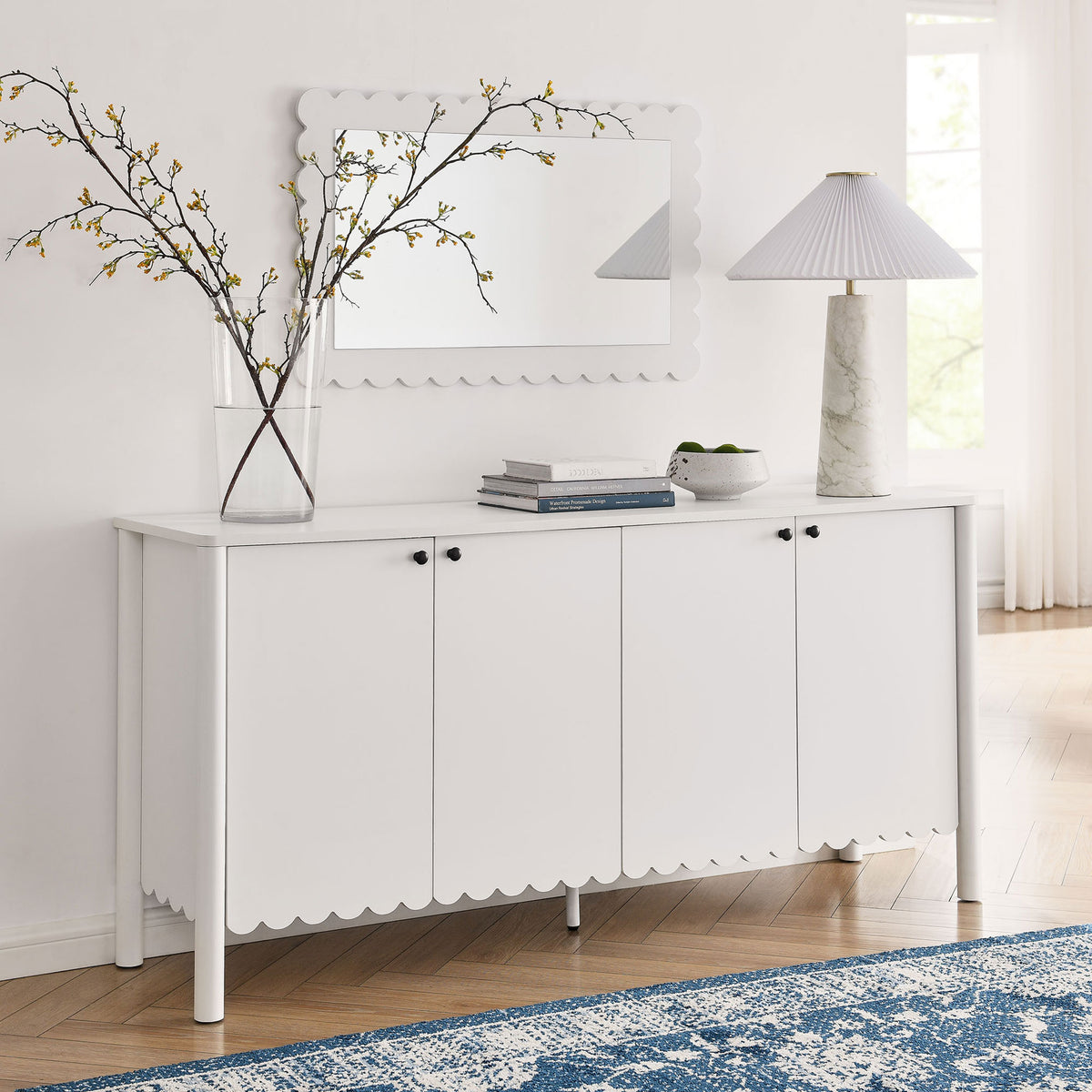 Emmeline white sideboard in a bright entryway, topped with mirror, vase, and lamp for welcoming style || EEI-7153-WHI || front_room