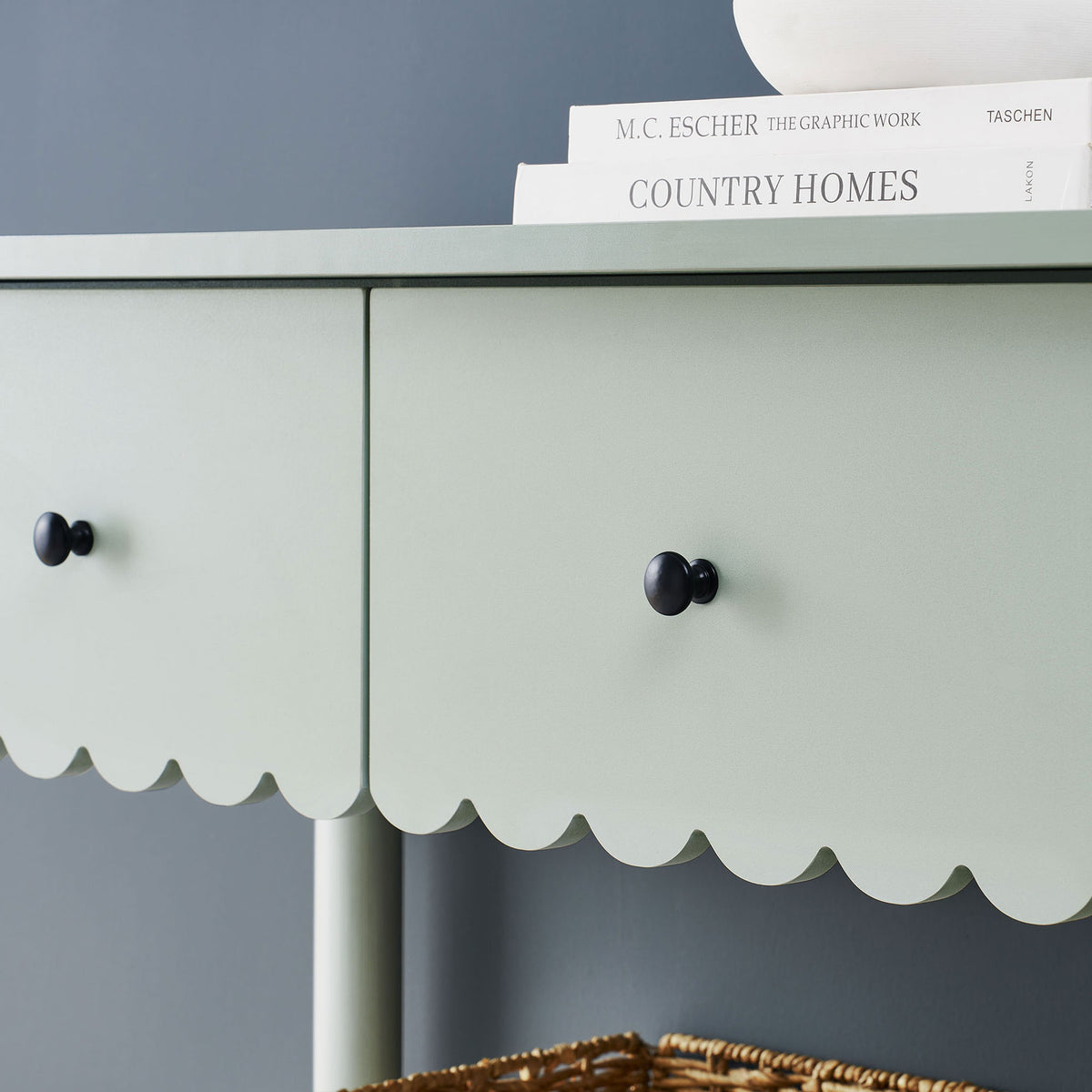 Matte black knobs contrast the soft sage finish and scalloped detailing for a refined touch. || EEI-7154-SGE || storage_room