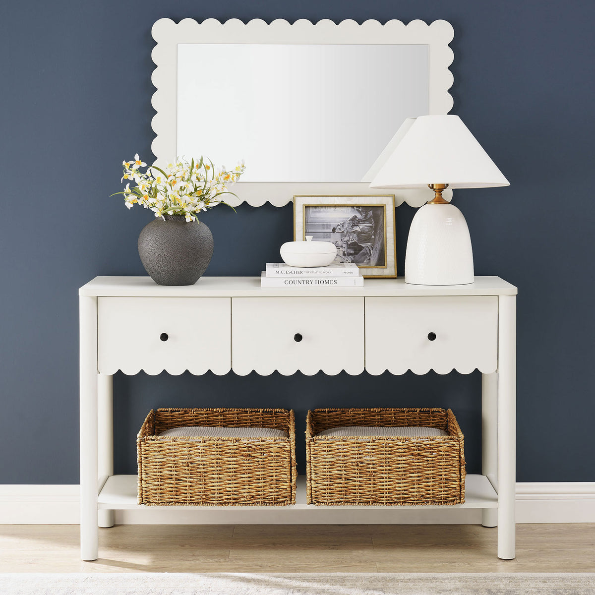 Styled entryway look highlights the console's airy lower shelf and charming scalloped detailing. || EEI-7154-WHI || front_room