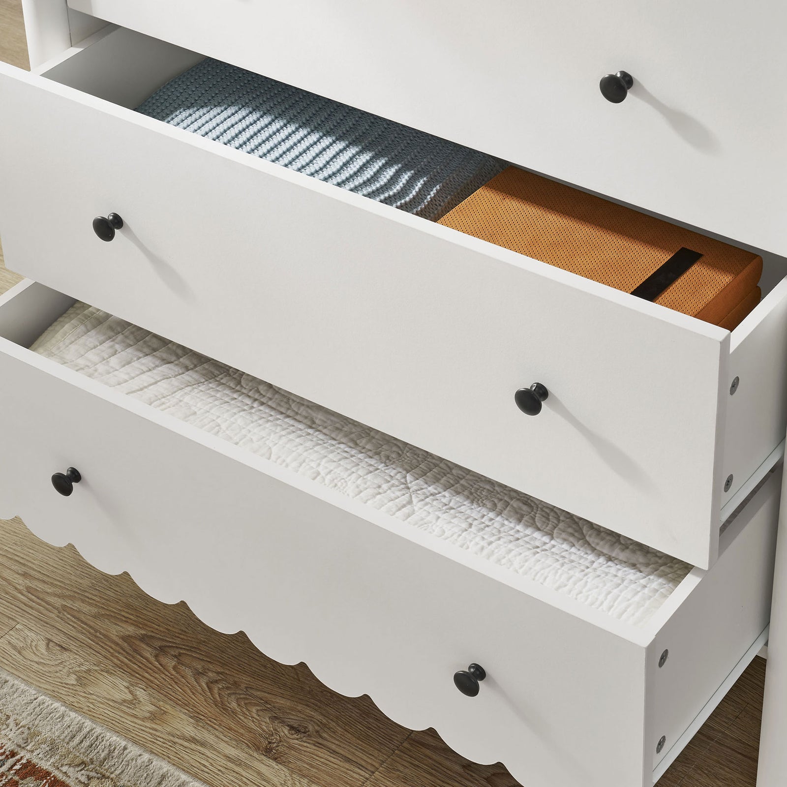 Open drawers neatly hold blankets and boxes, showing how the Emmeline chest keeps everyday essentials organized. || EEI-7156-WHI || storage_open_room