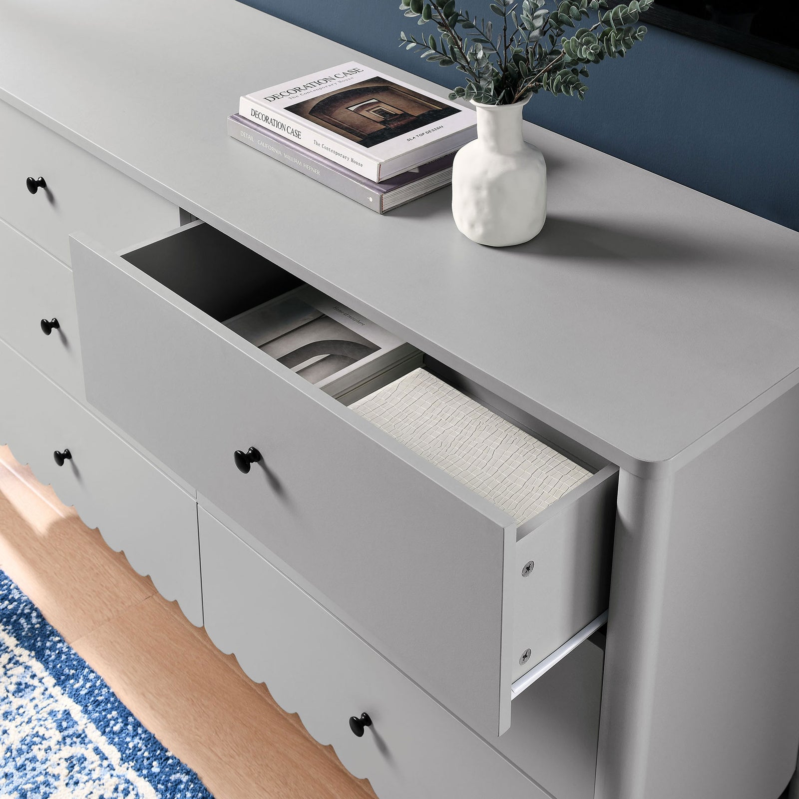 Styled dresser vignette with an open drawer neatly organizing linens beneath a sleek gray top. || EEI-7157-LGR || storage_open_room