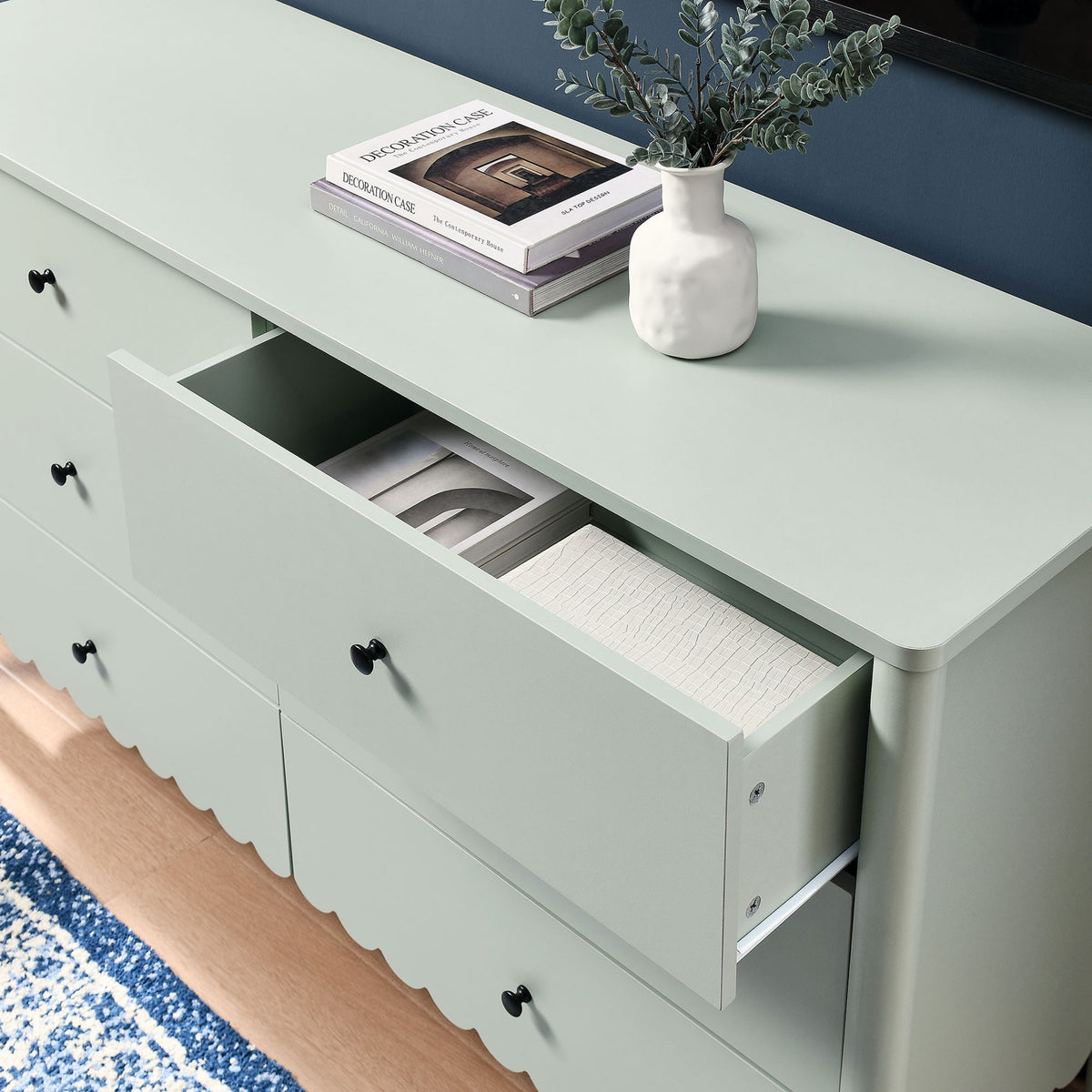 Dresser styled under a TV with decor pieces and an open drawer displaying neatly arranged accessories. || EEI-7157-SGE || storage_open_room
