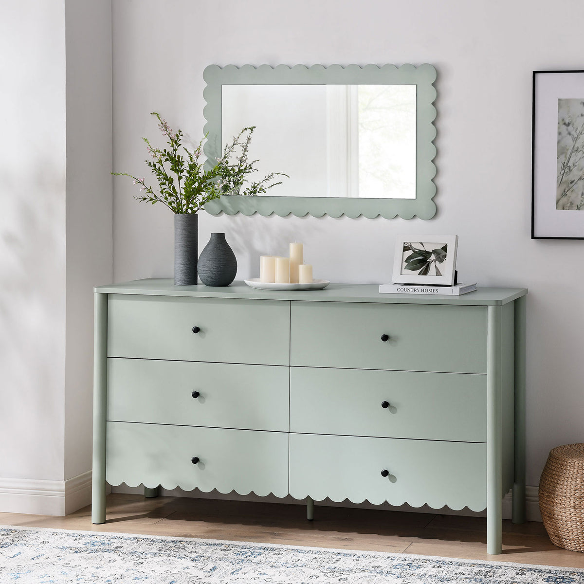 Scalloped dresser styled with matching mirror and soft decor, adding charm to a bright bedroom. || EEI-7157-SGE || front_angle_room