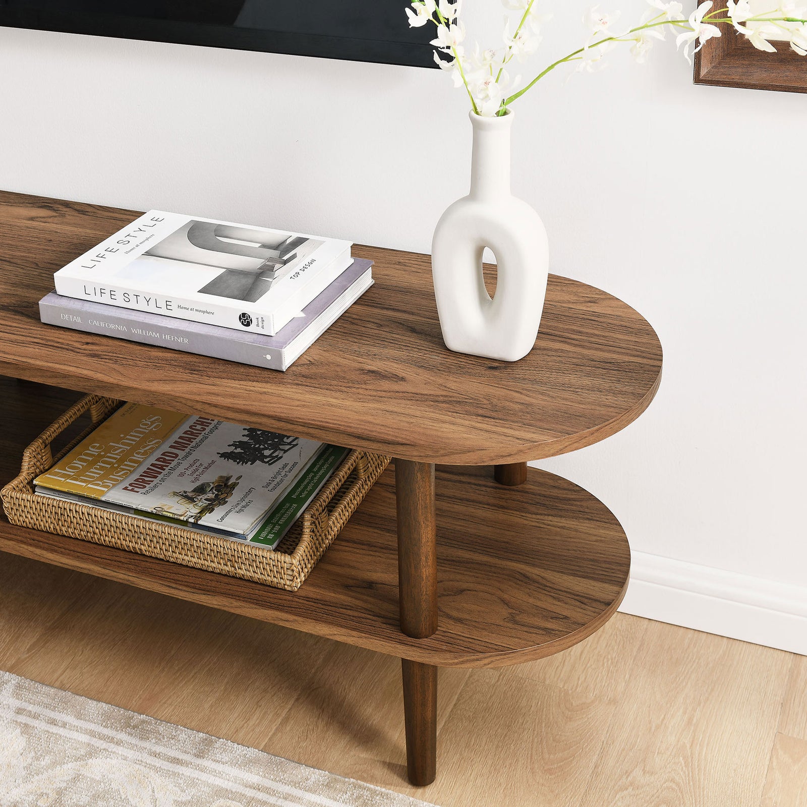 Walnut Torus TV stand styled with books, a vase, and basket to show everyday storage || EEI-7158-WAL || detail_room
