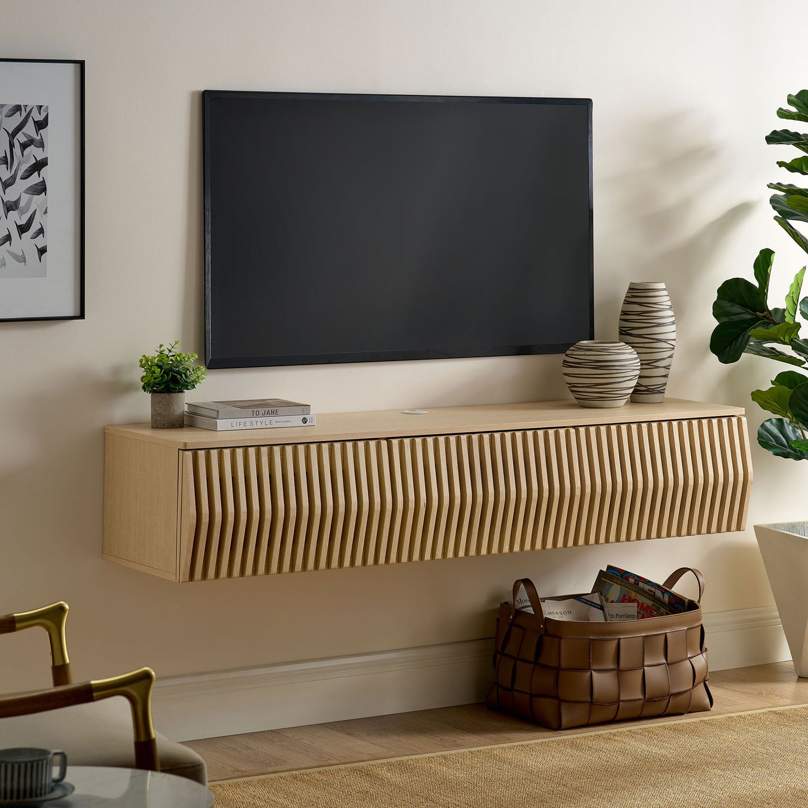 Ash floating TV console styled under a wall-mounted screen in a modern living room || EEI-7164-ASH || front_angle_room