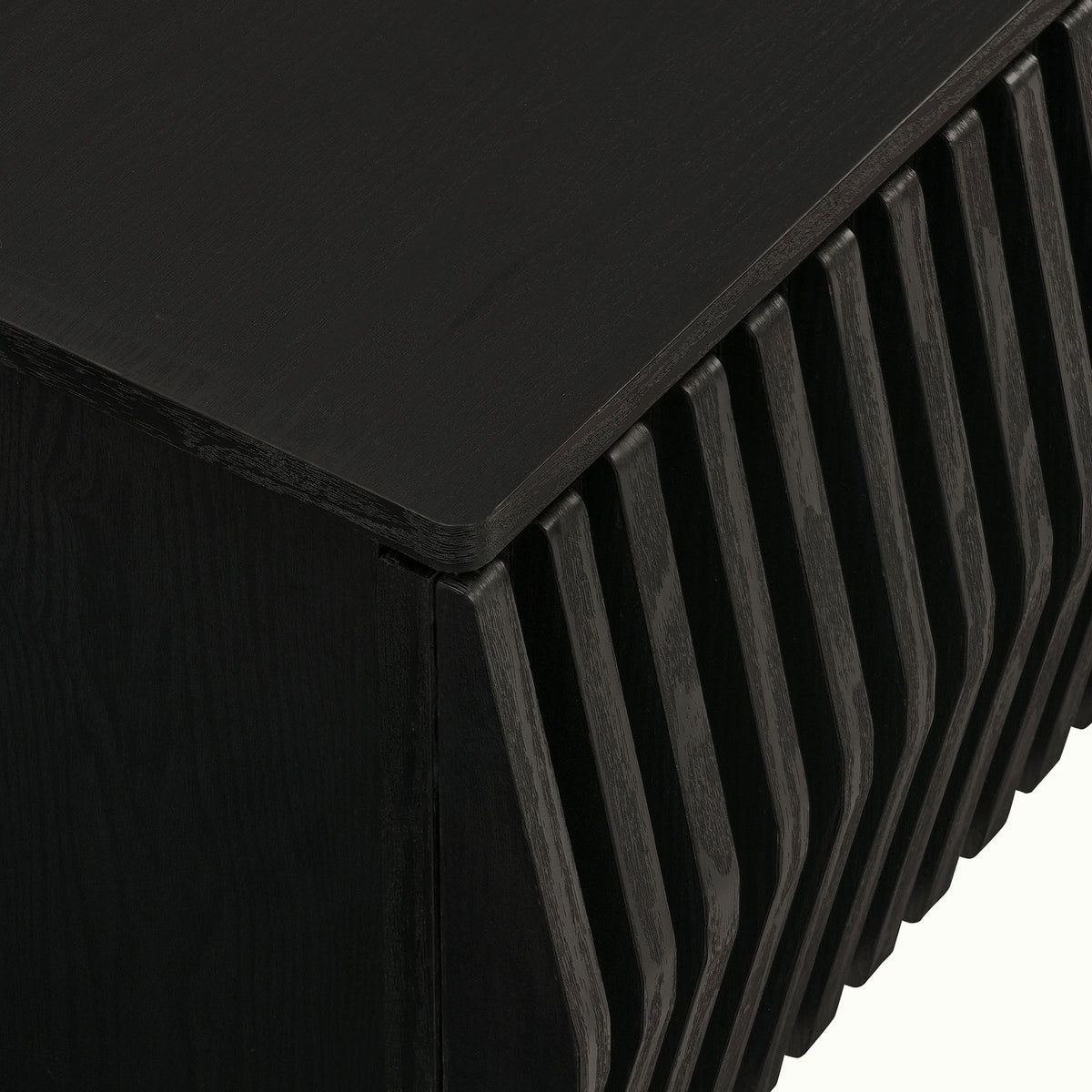 Black TV stand corner detail featuring rounded top and dimensional slatted front || EEI-7164-BLK || detail_studio