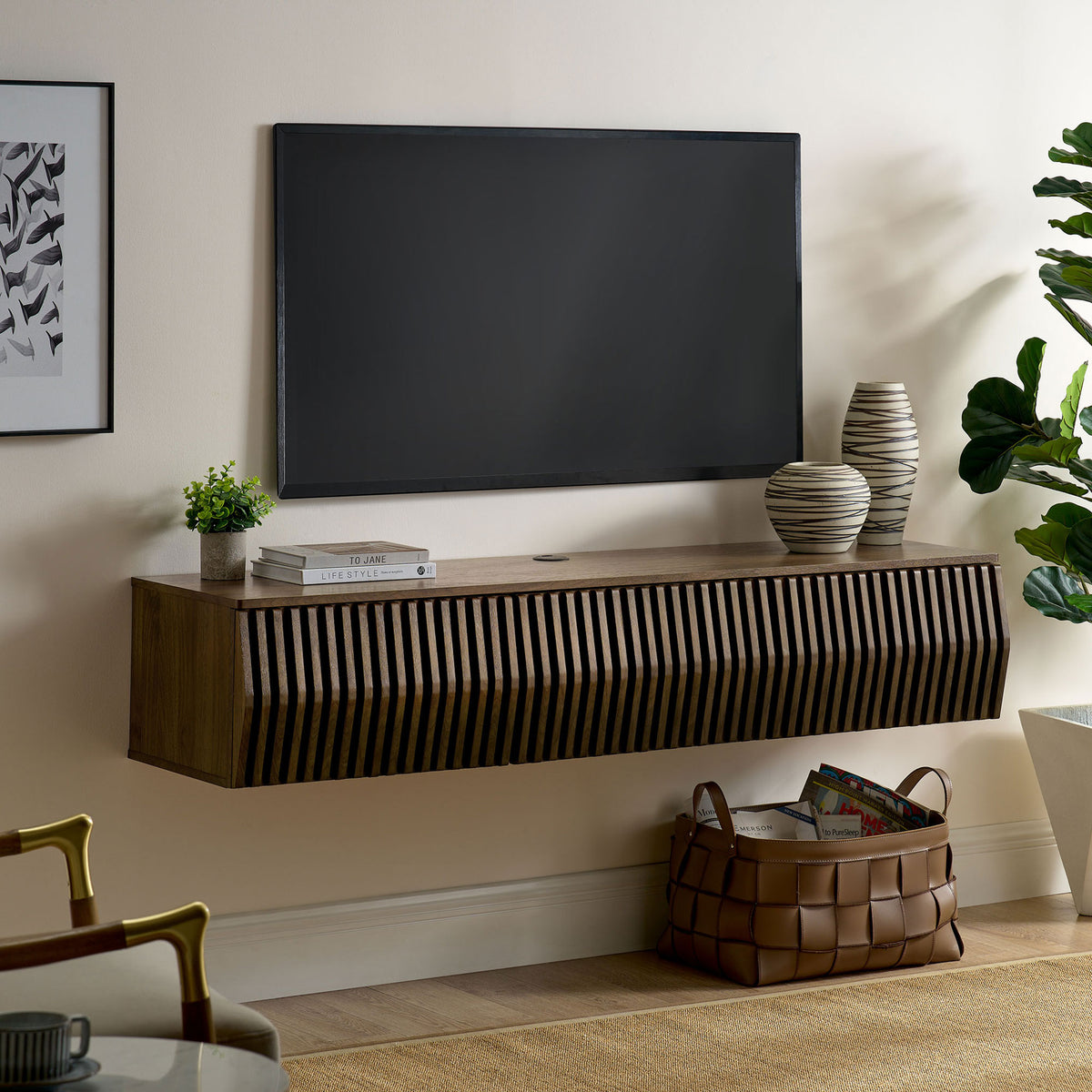 Walnut floating TV console installed beneath a wall-mounted screen in a cozy living room || EEI-7164-WAL || front_angle_room