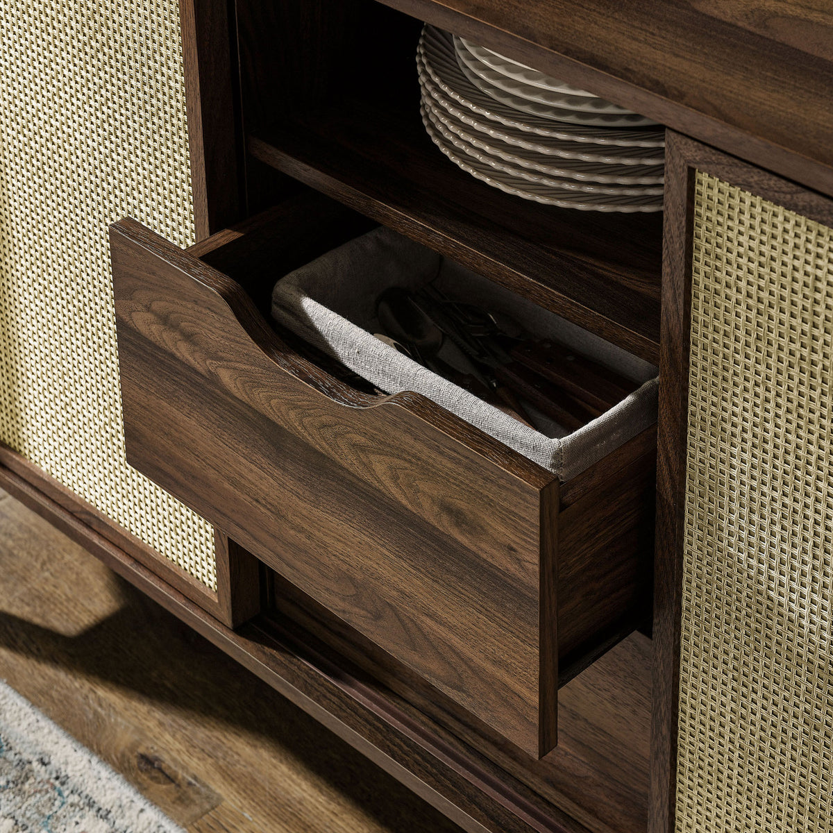 Drawer storage keeps flatware and linens neatly organized within the stylish walnut sideboard || EEI-7166-WAL || storage_open_room
