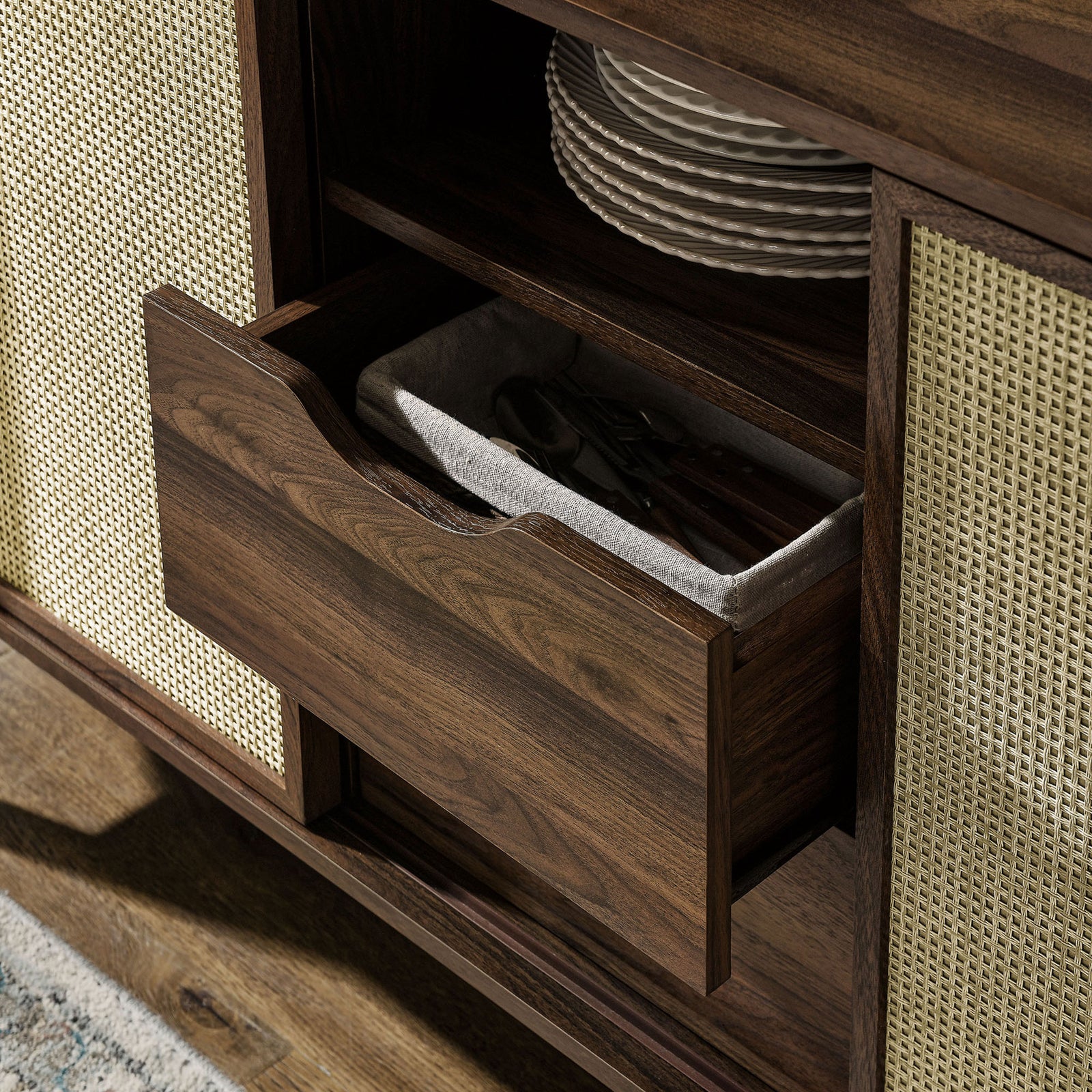Drawer storage keeps flatware and linens neatly organized within the stylish walnut sideboard || EEI-7166-WAL || storage_open_room