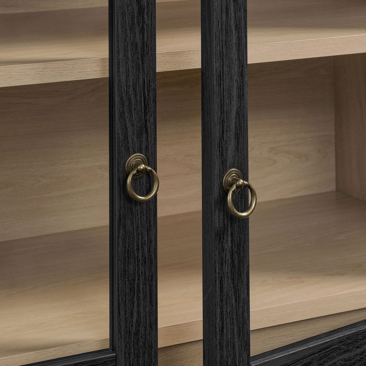 Brushed gold ring pulls stand out against the black oak frame and glass doors || EEI-7168-BLK-OAK || handle_studio