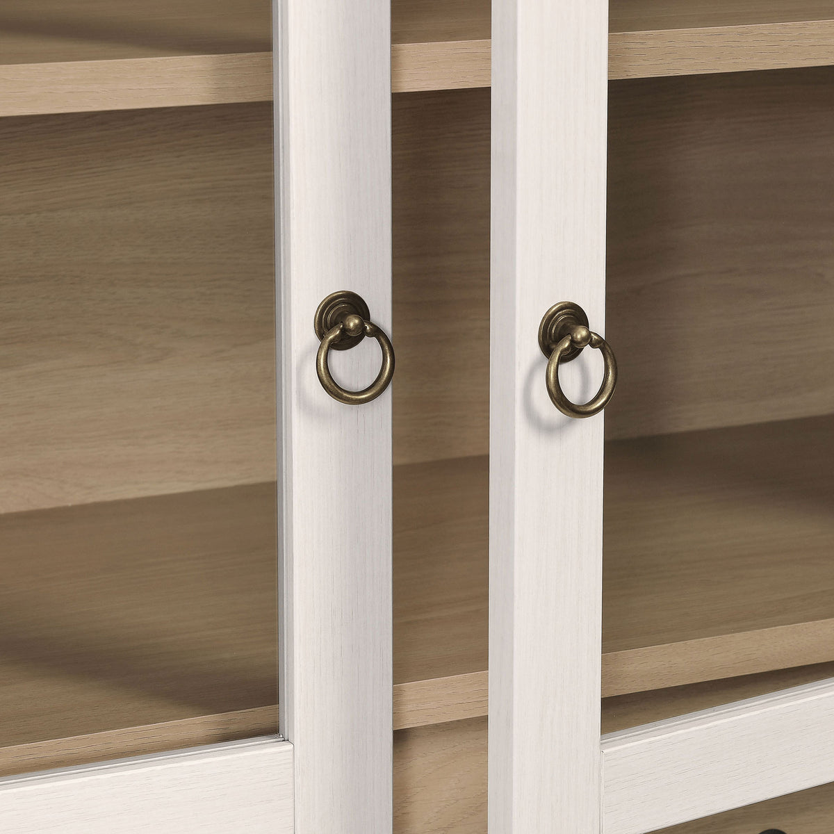 Antique brass ring pulls complement the soft ivory oak frame and glass doors || EEI-7168-IVO-OAK || handle_studio