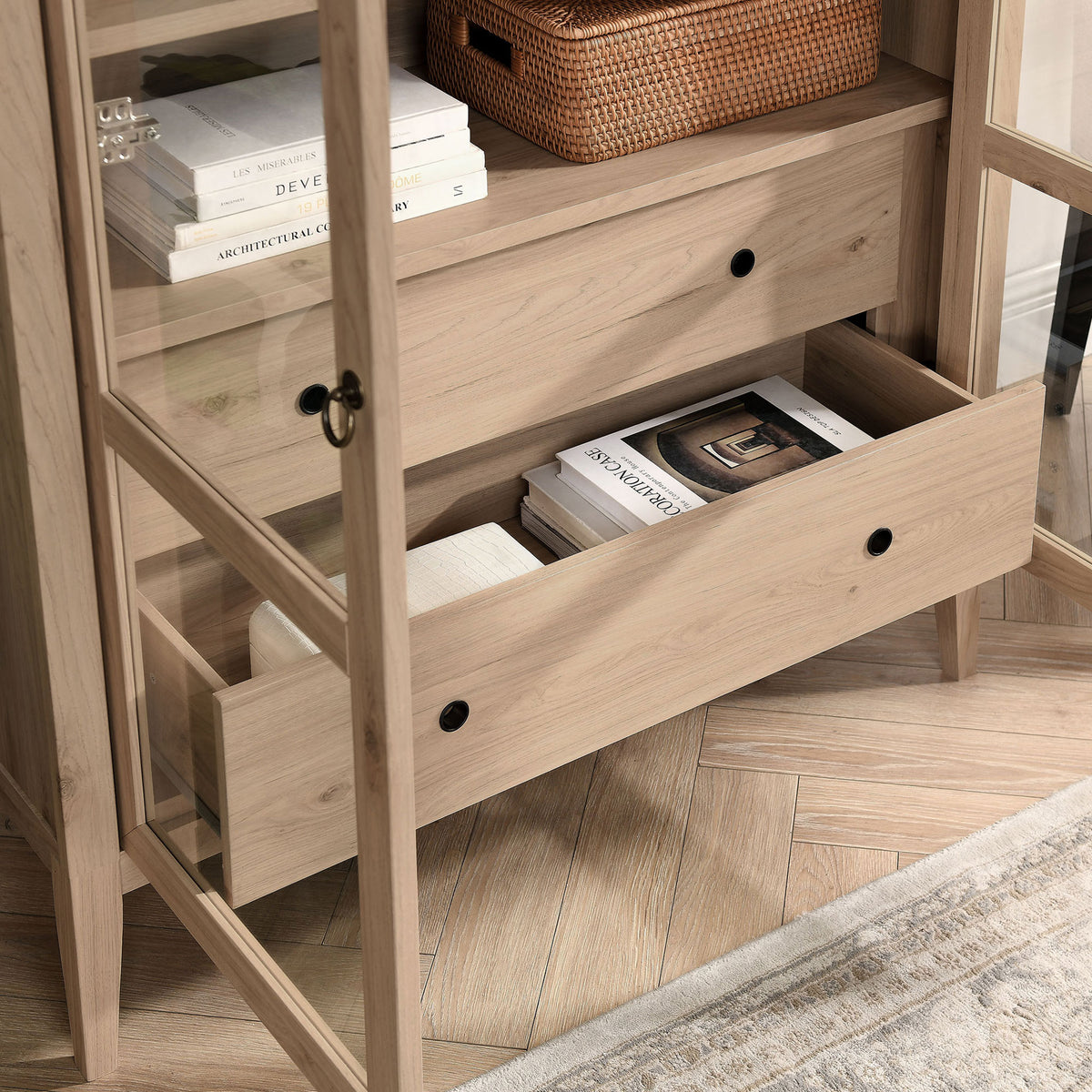 Lower drawer of the light oak cabinet holding books, throws, and everyday accents || EEI-7168-LOA || storage_open_room