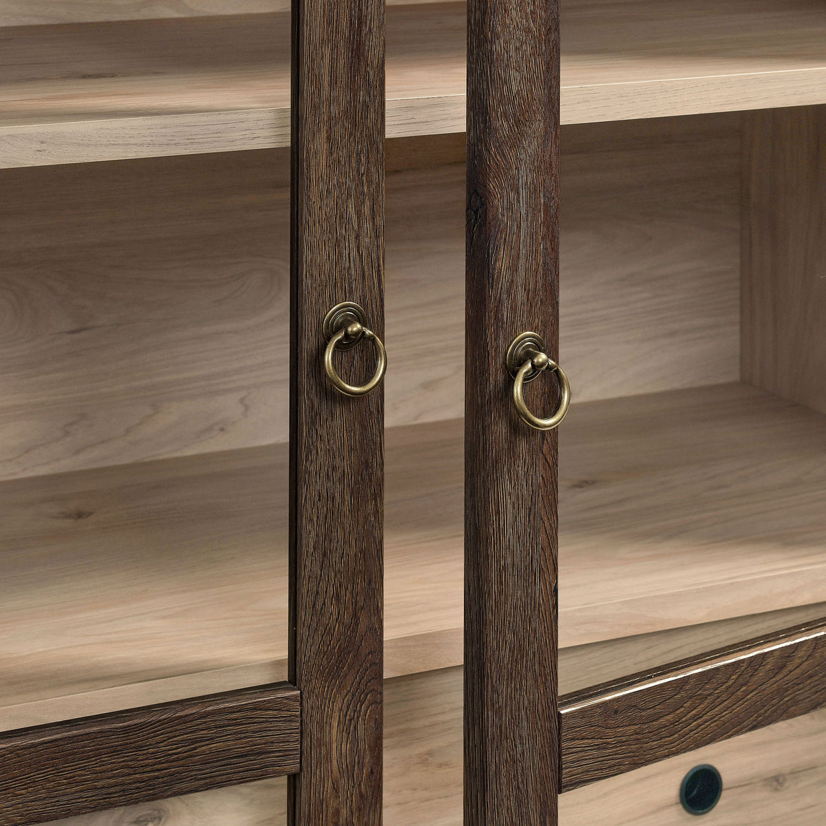 Brushed gold ring pulls enrich the dark walnut frame and light oak interior of the doors || EEI-7168-WAL-LOA || handle_studio