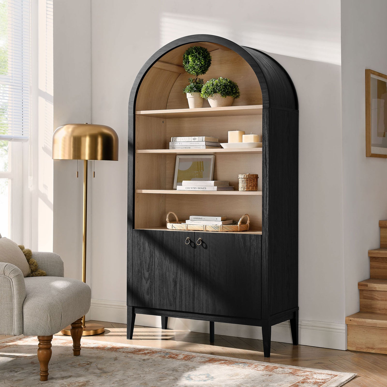 Statement arched cabinet elevates a living space with black oak exterior and natural wood interior || EEI-7169-BLK-OAK || front_angle_room