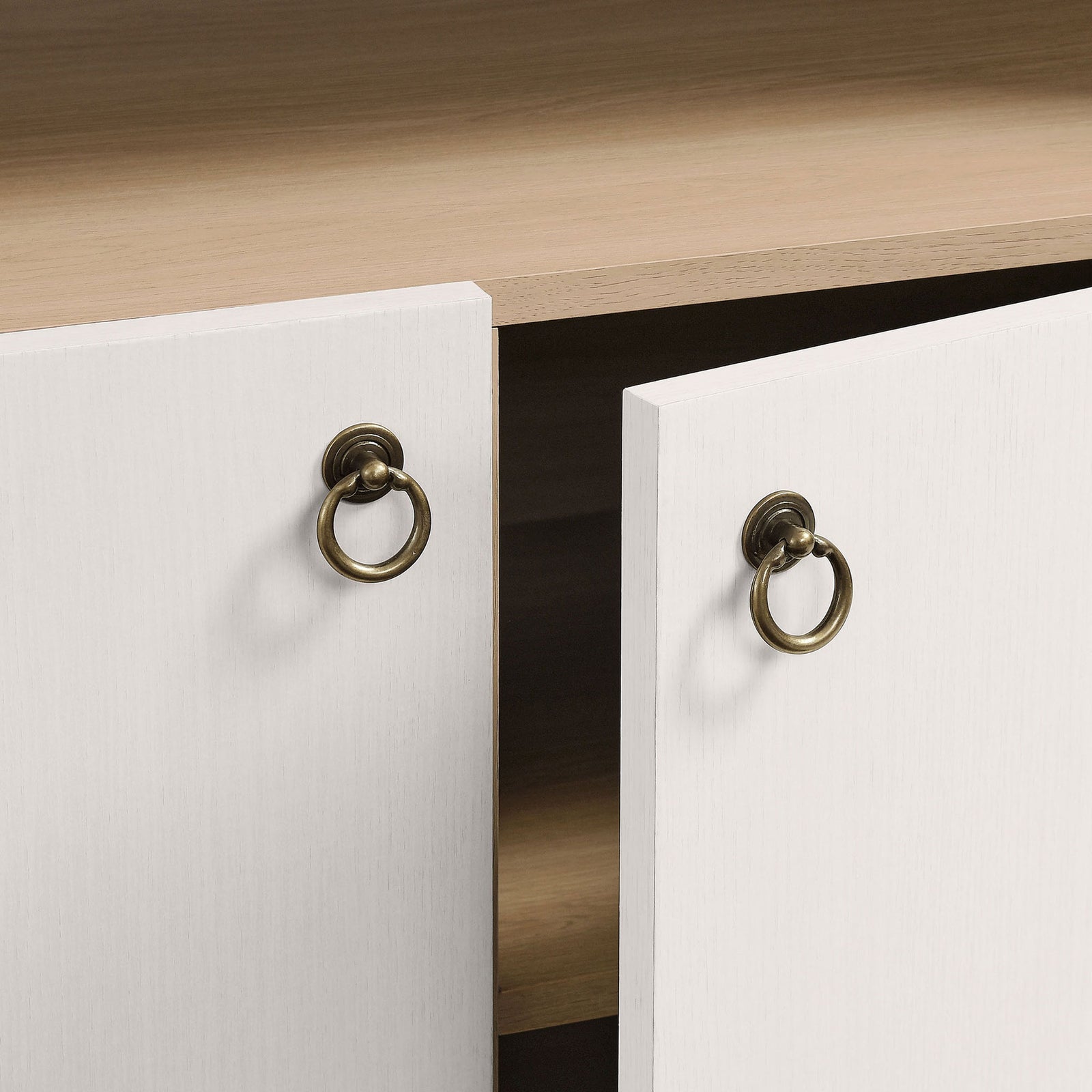 Brushed gold metal ring pulls add a refined touch to the cabinet doors || EEI-7169-IVO-OAK || handle_studio