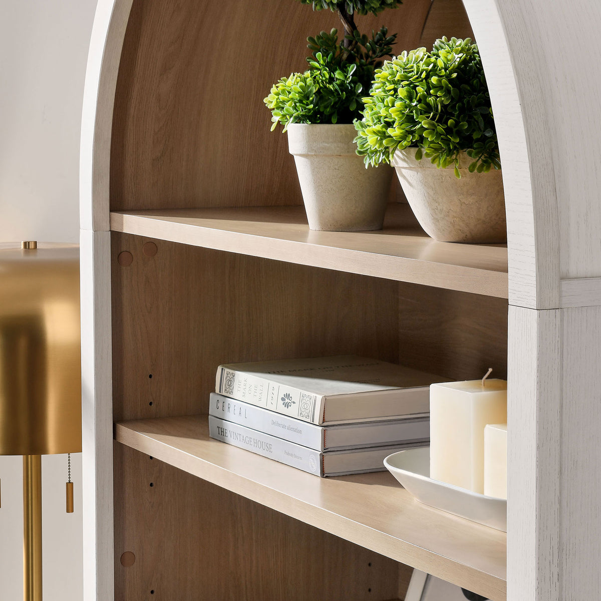 Rounded arch and wood-grain shelving styled with decor for a warm, inviting look || EEI-7169-IVO-OAK || detail_room