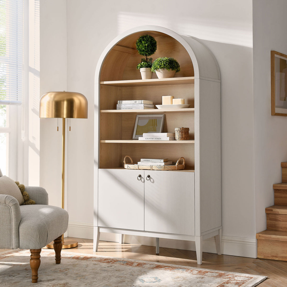 Statement arched cabinet elevates a bright living space with ample display and concealed storage || EEI-7169-IVO-OAK || front_angle_room