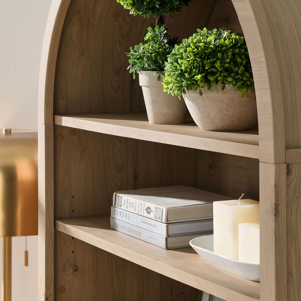 Curved arch and spacious shelves accommodate books and decor with ease || EEI-7169-LOA || detail_room