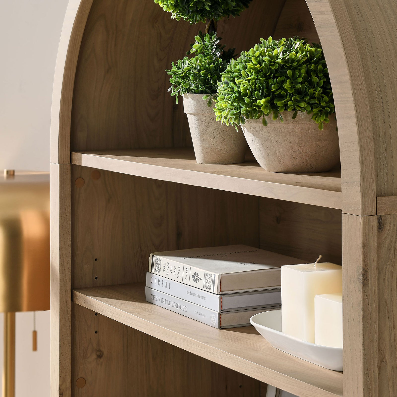 Curved arch and spacious shelves accommodate books and decor with ease || EEI-7169-LOA || detail_room