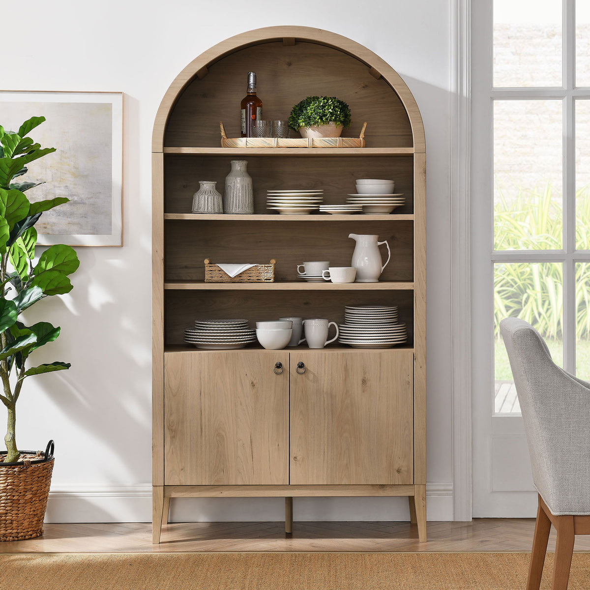 Styled arched cabinet showcases dinnerware on open shelves and concealed storage below || EEI-7169-LOA || front_room