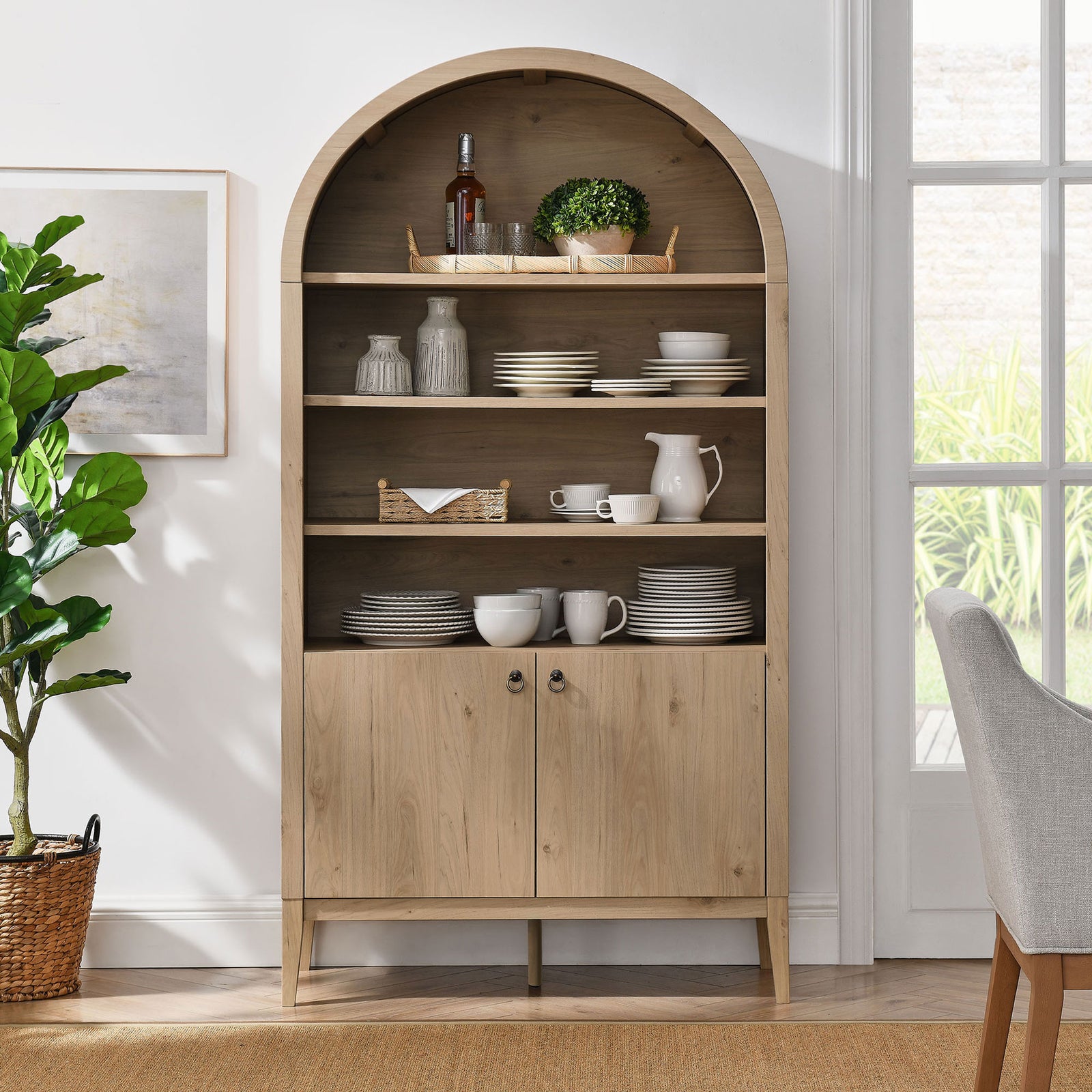 Styled arched cabinet showcases dinnerware on open shelves and concealed storage below || EEI-7169-LOA || front_room