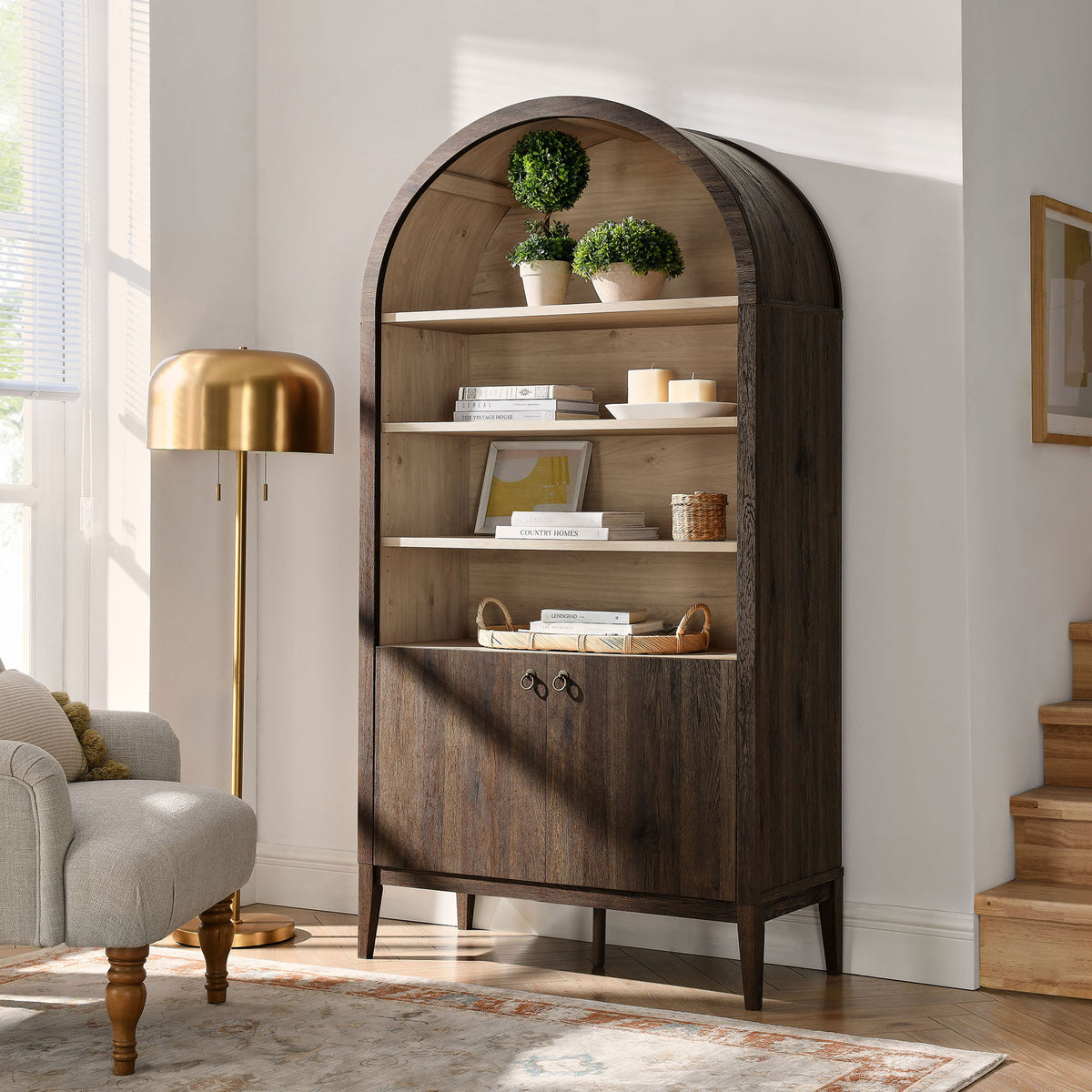 Arched storage cabinet anchors the living room with vintage charm and everyday function || EEI-7169-WAL-LOA || front_angle_room