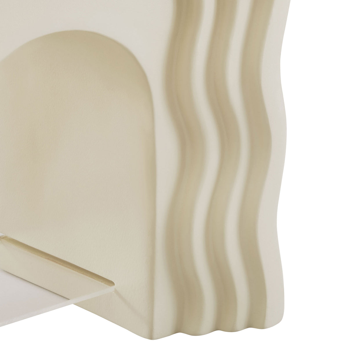 Textured ivory faux stone finish and clear acrylic shelf add depth to the sculptural squiggle table || EEI-7171-IVO || detail_studio