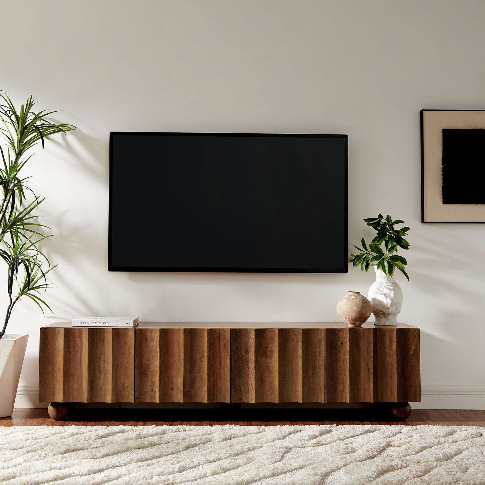 Walnut long TV stand styled in a soft neutral living space beneath a mounted television || EEI-7184-WAL || front_angle_room