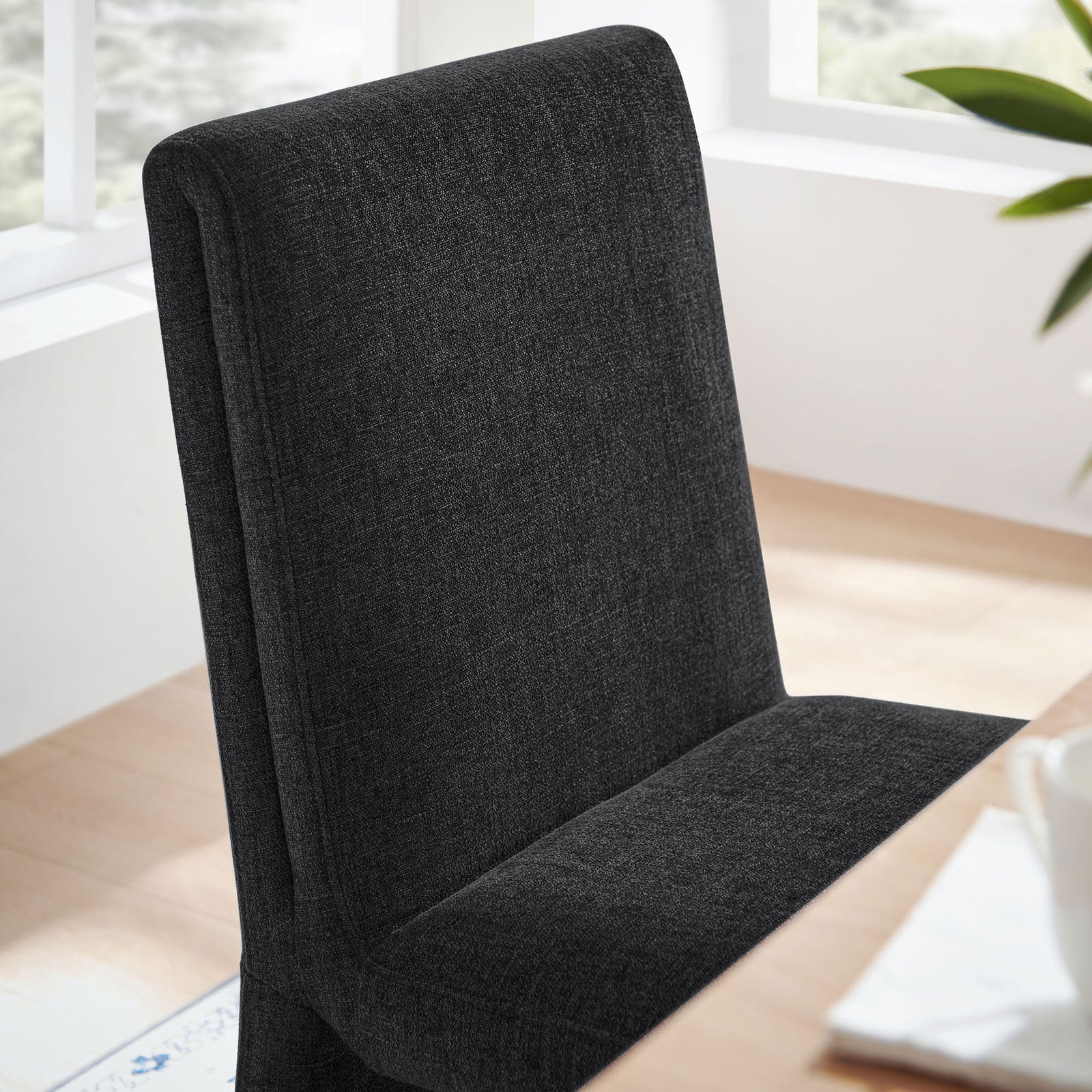 Ebony dining chair at a light wood table creating a cozy modern dining nook || EEI-7185-EBO || detail_room