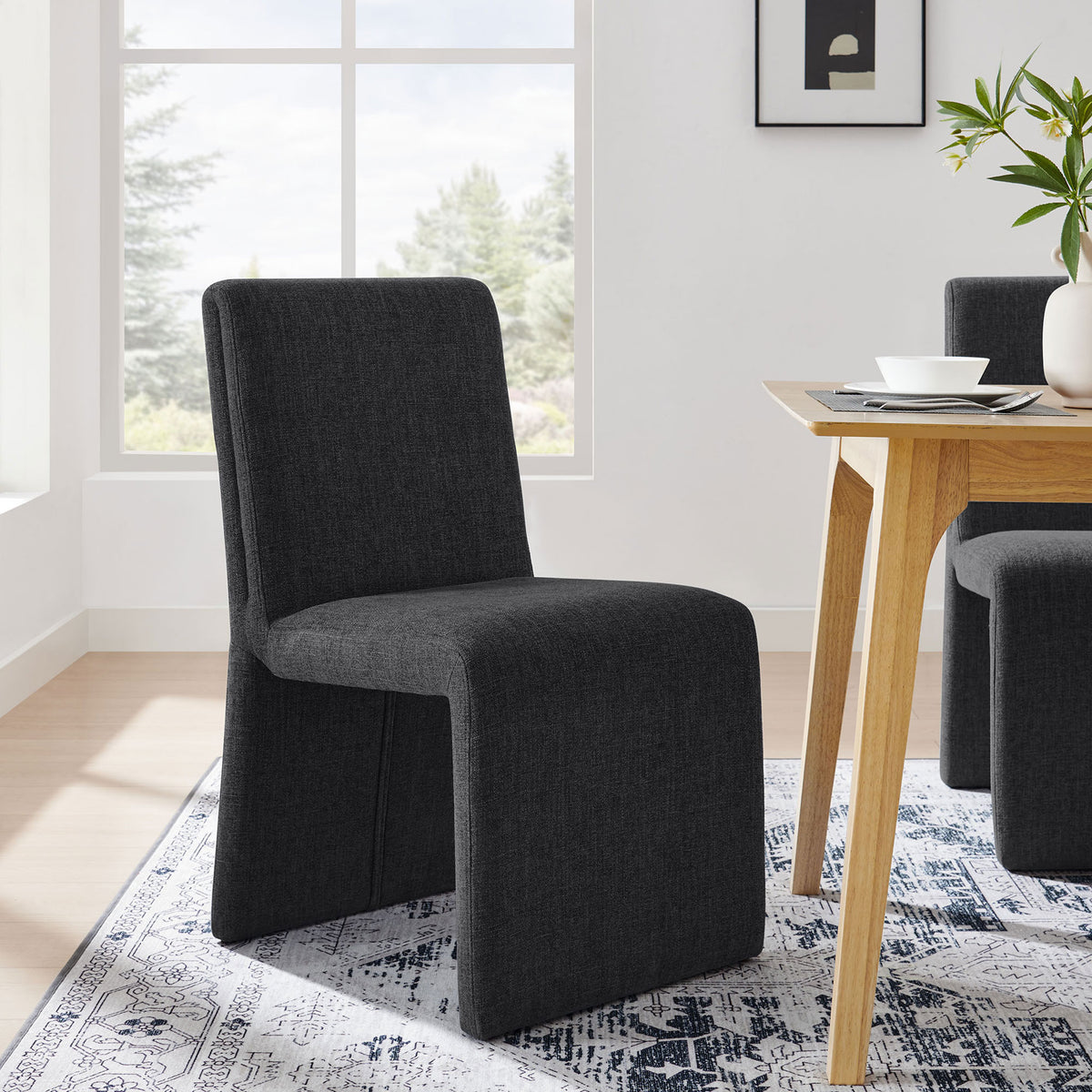 Emory ebony dining chair in a bright dining room paired with a wood table and rug || EEI-7185-EBO || front_angle_room