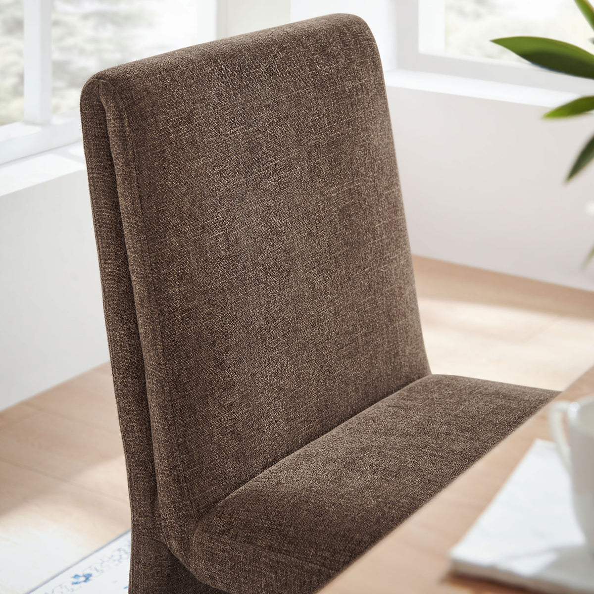 Textured mocha fabric backrest adding soft comfort at a bright dining table setting. || EEI-7185-MOC || detail_room