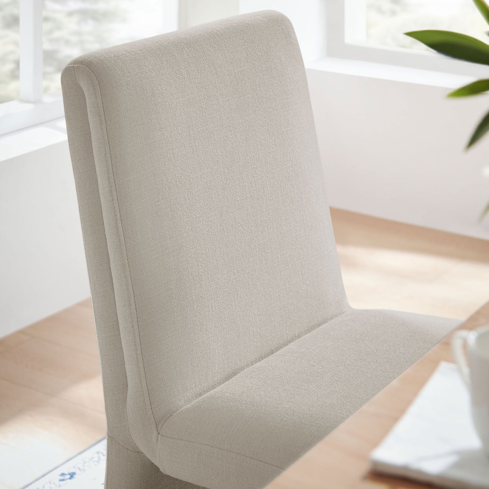 Emory salt fabric dining chair backrest adding soft texture and comfort to a bright modern dining room || EEI-7185-SAL || detail_room