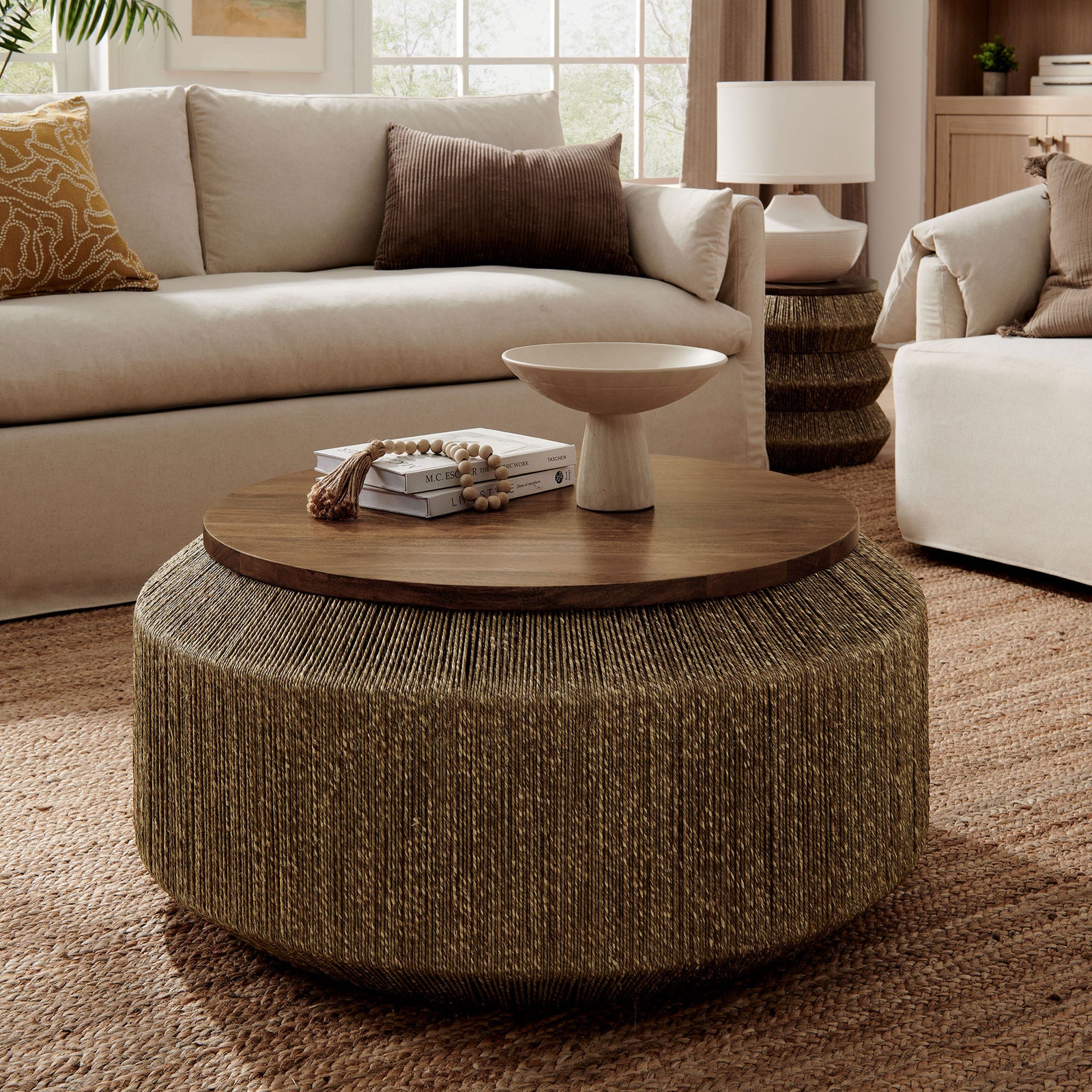 Sculptural round coffee table blending seagrass texture with a solid mango wood top || EEI-7187-WAL-NAT || front_angle_room