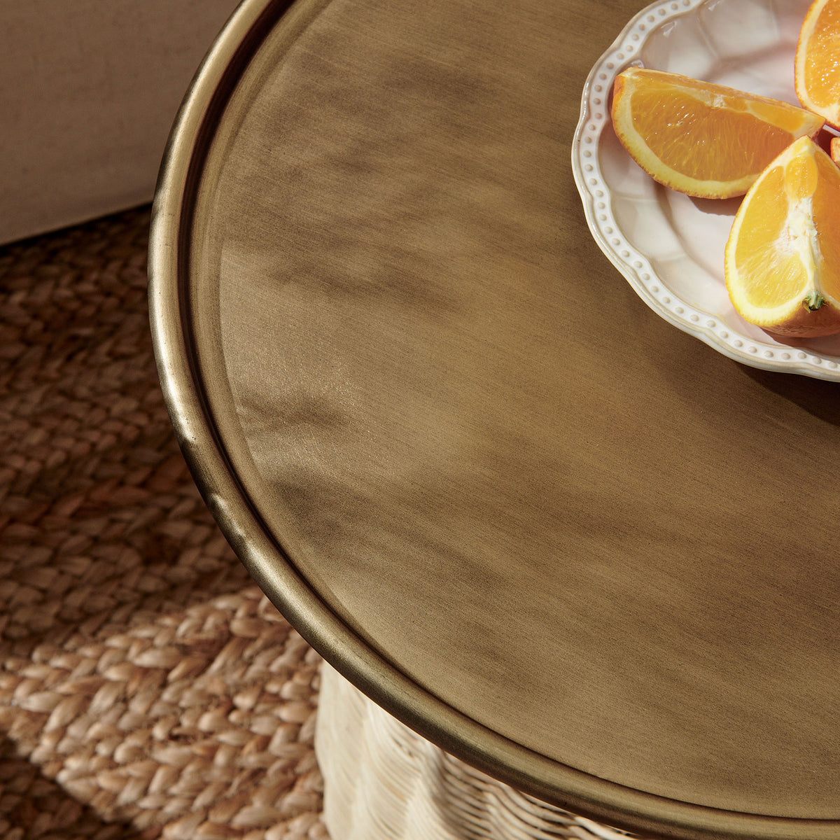 Brass tray top styled with citrus and glassware brings a warm, coastal touch to the woven table. || EEI-7189-BBR-NAT || detail_room