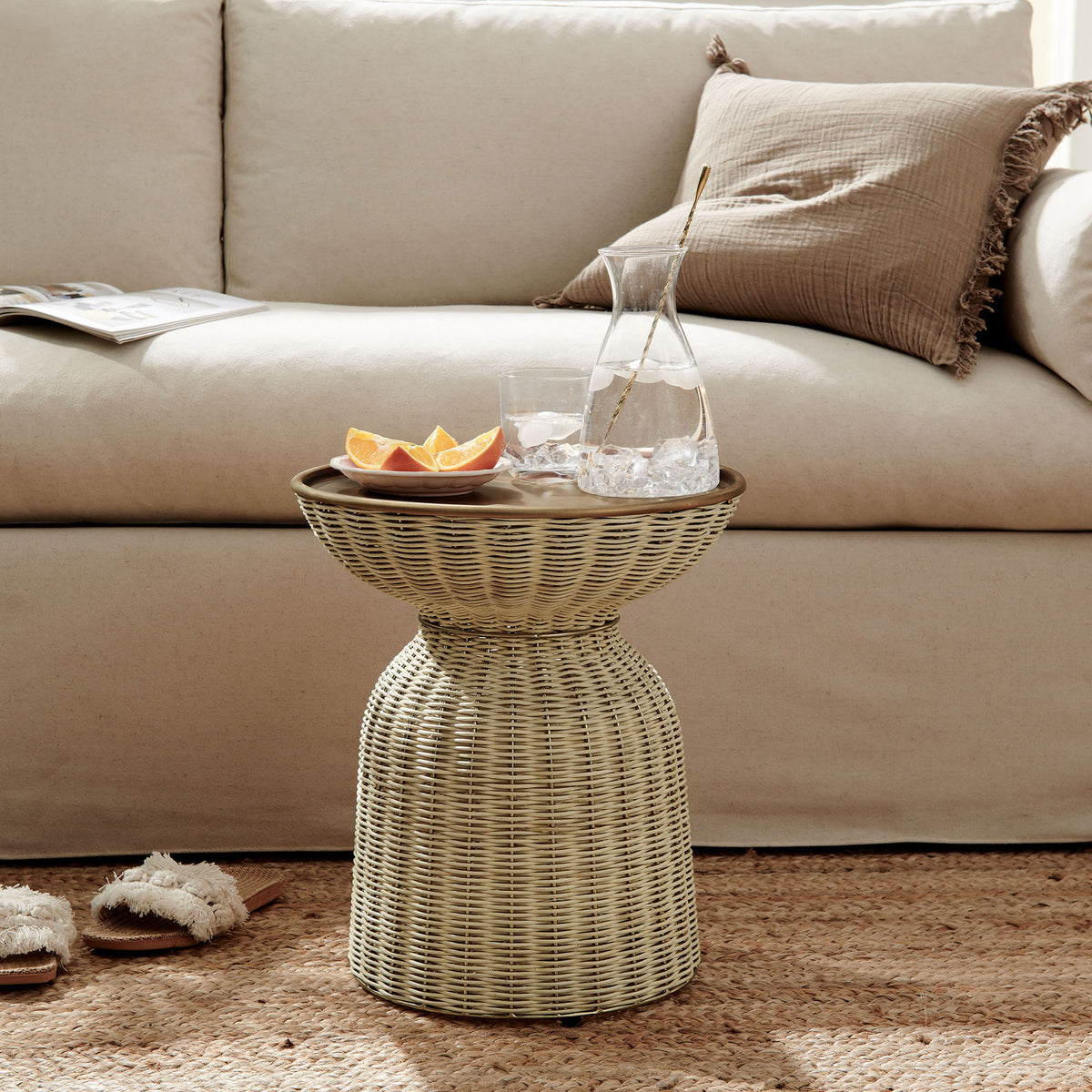 Lazaro rattan side table pairs effortlessly with a neutral sofa and jute rug for relaxed living. || EEI-7189-BBR-NAT || front_angle_room