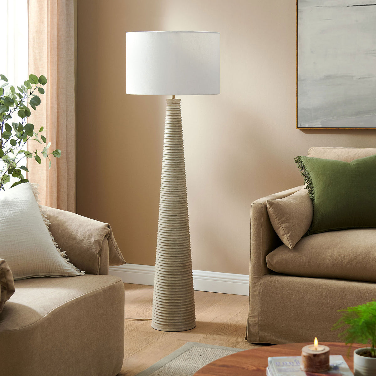 Ribbed wood floor lamp with white shade styled beside a soft neutral sofa || EEI-7190-WHI-GRY || front_room